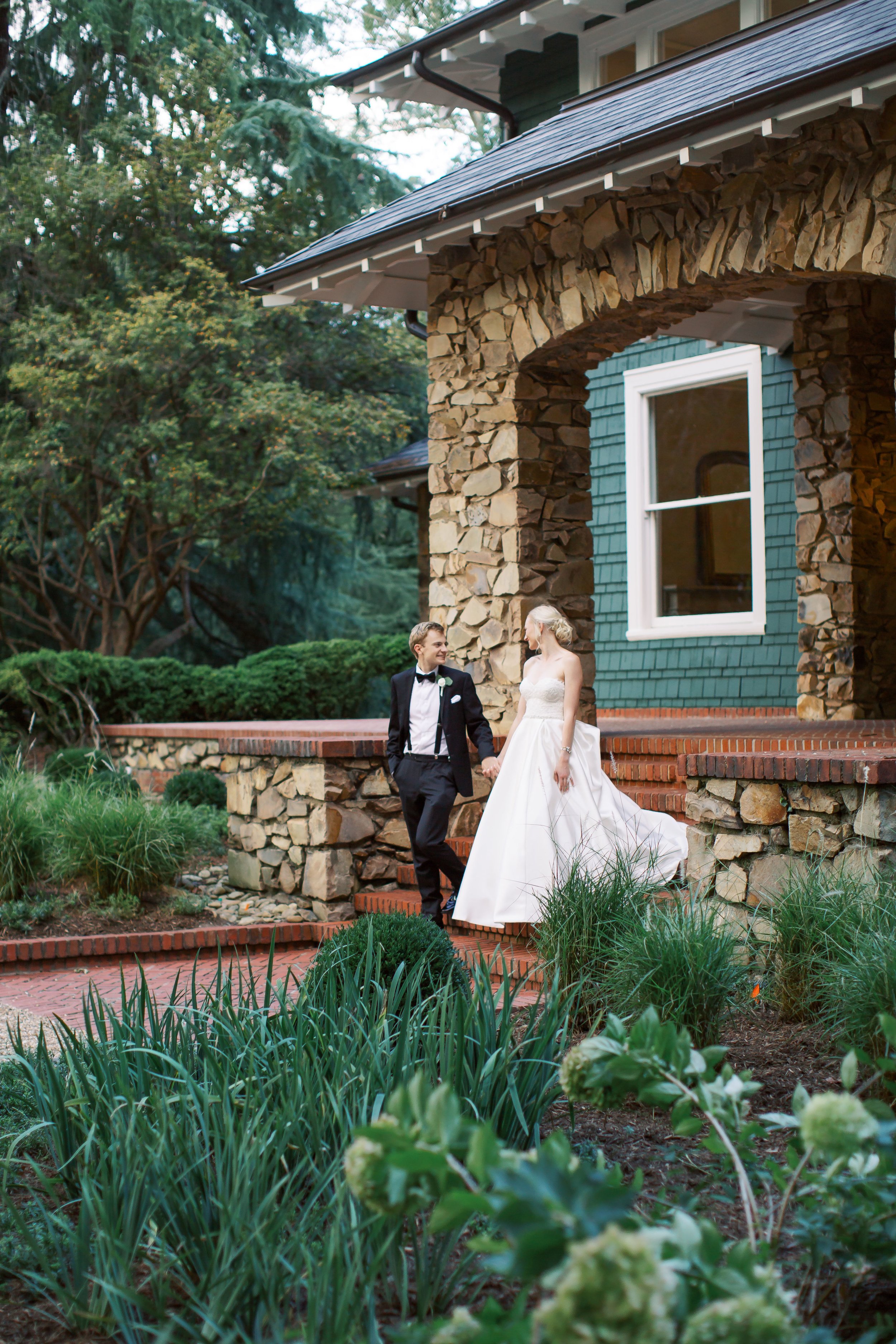 bride and groom walk down stairs at vanlandingham estate