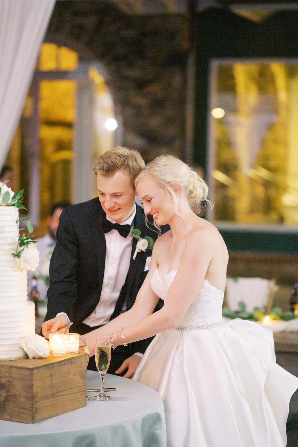 bride and groom cut cake 
