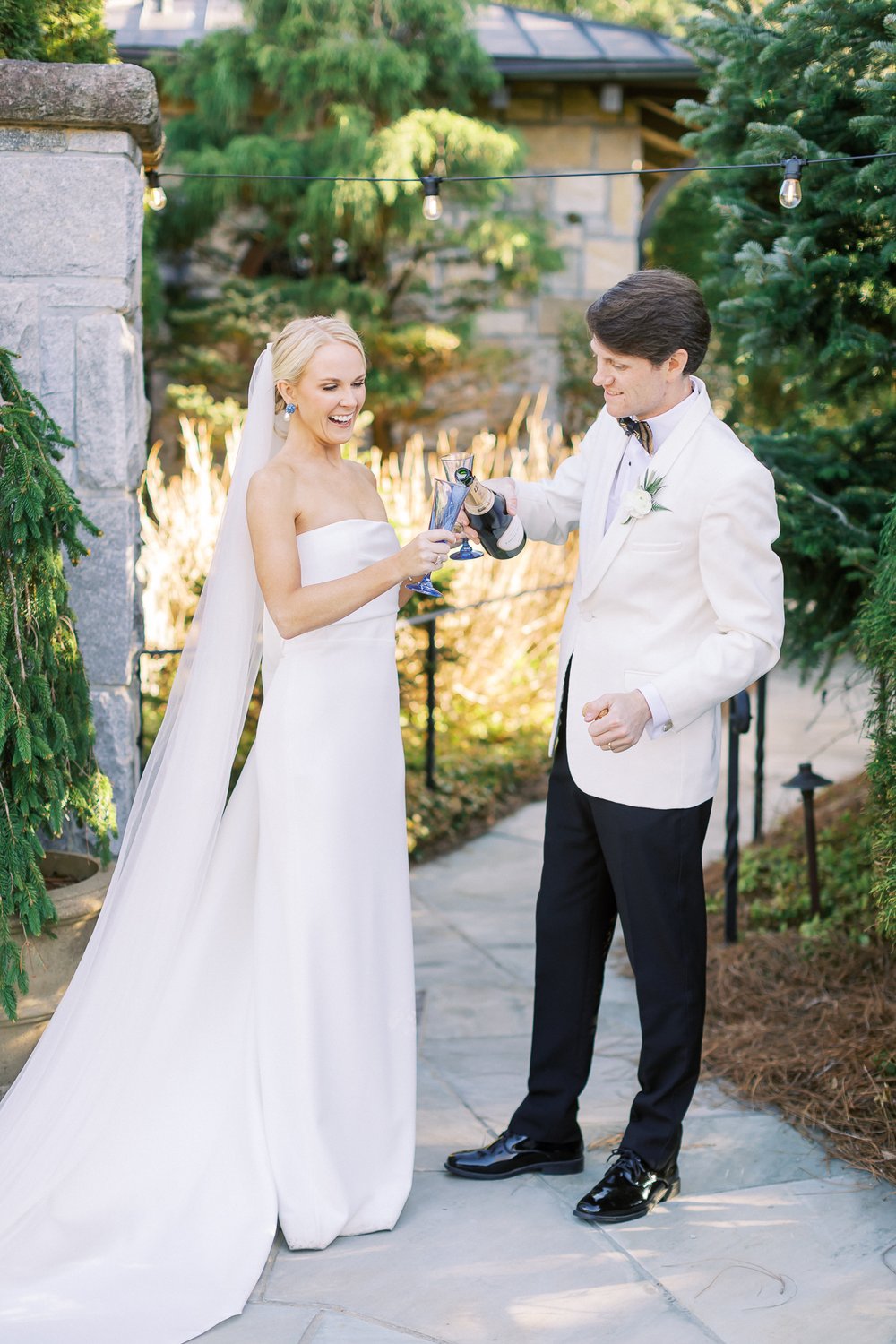 Bride and Groom pouring champagne at wedding