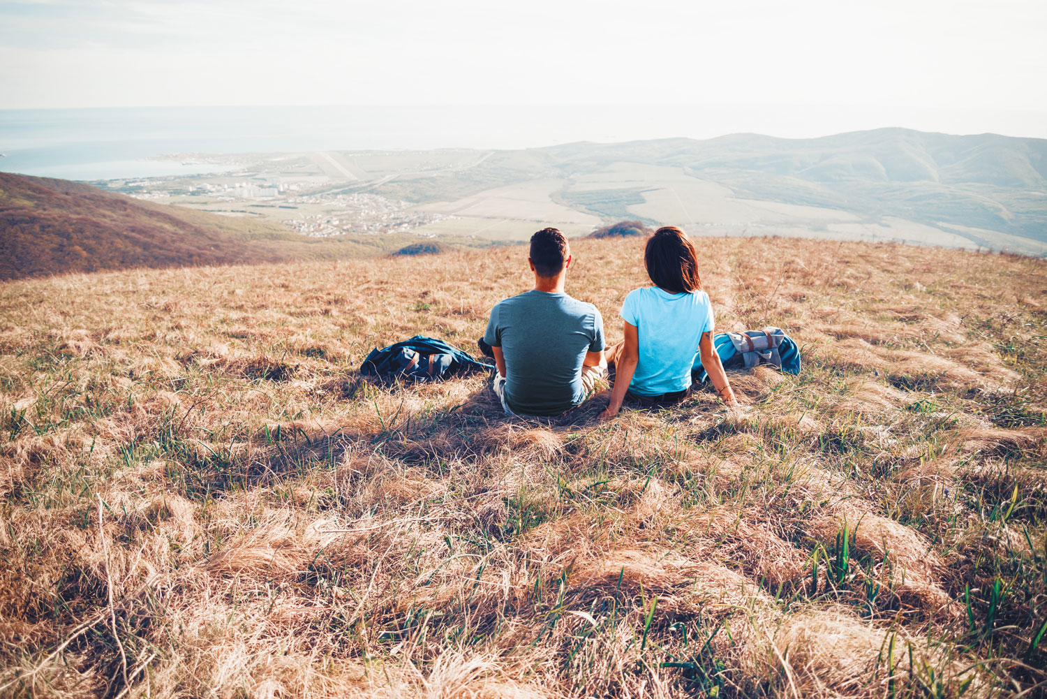 Brother and sister having deep and meaningful chats on a mountain. bella magazine 