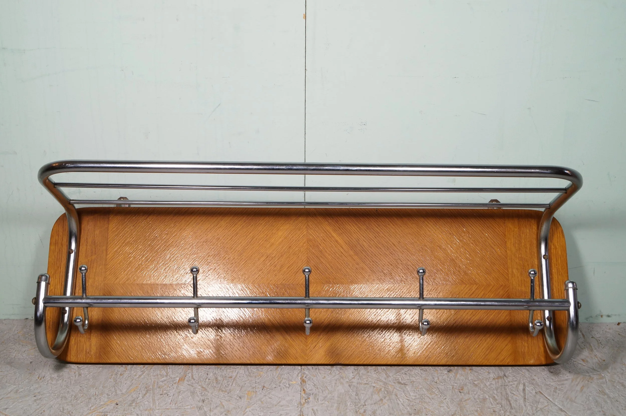 Een wandrek met een houten plank en metalen haarspeldvoet en stangen