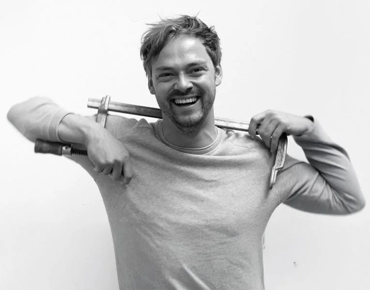 Roel, founder of Frümel, in the workshop with a smile and a glue stick - specialist in vintage furniture