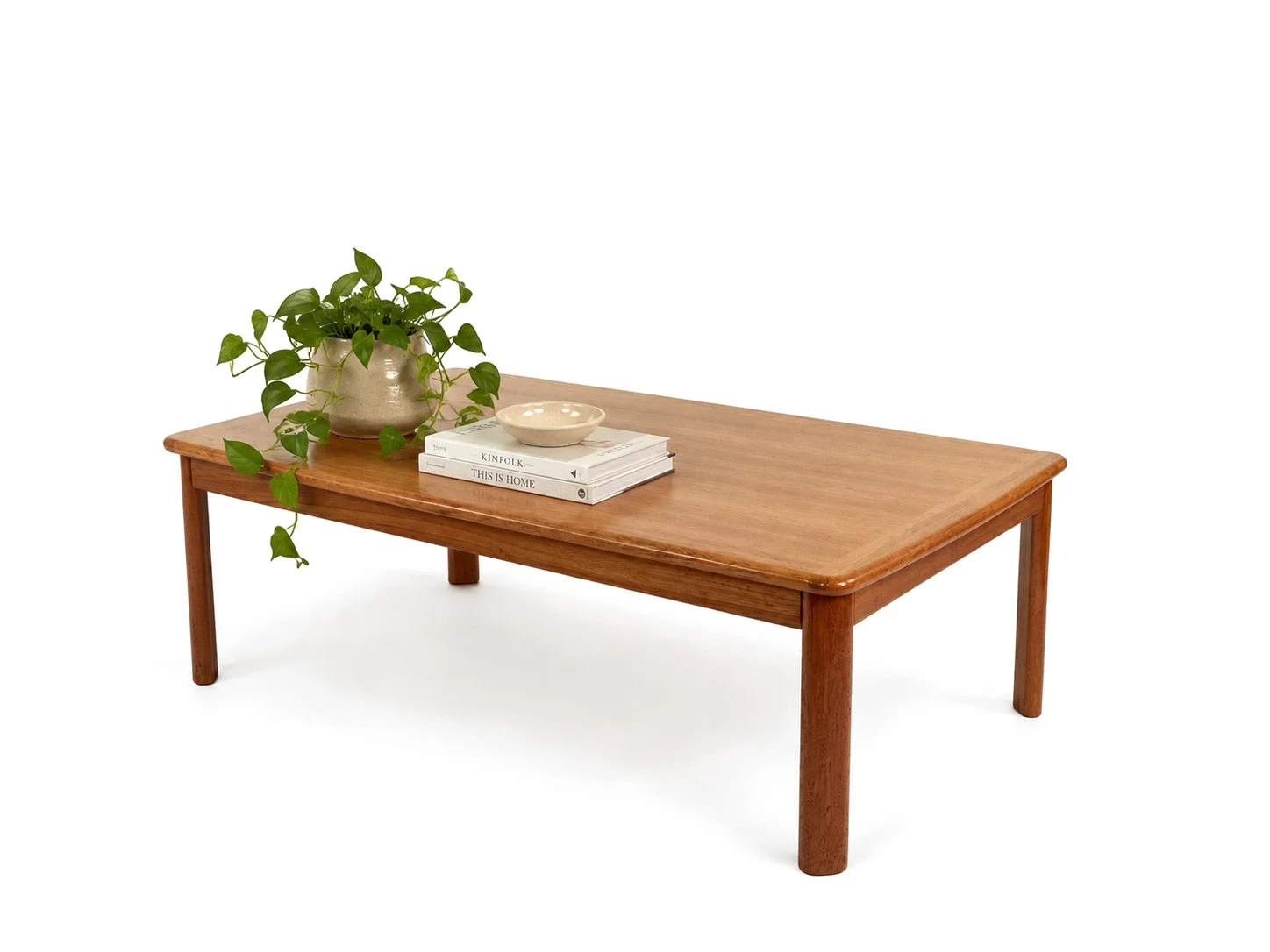 Deense design salontafel van Niels Bach in teak – schuin zijaanzicht rechts met kamerplant, keramische schaal en boeken