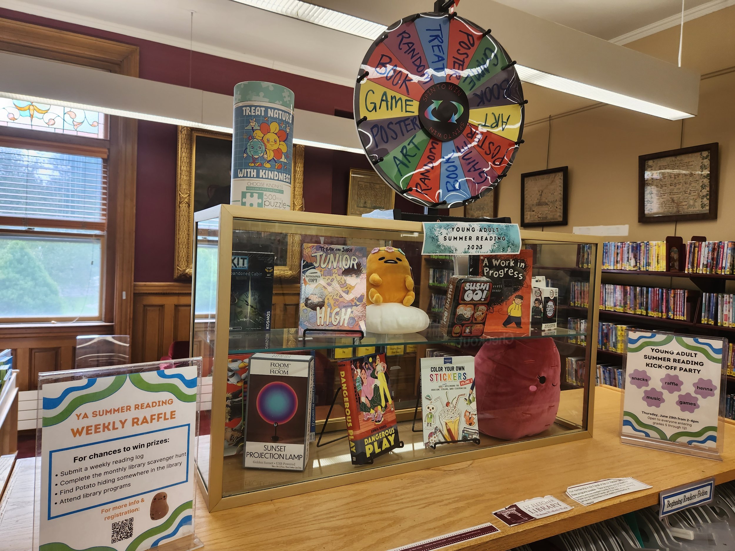 Prize wheel and prizes for participants in the Young Adult summer reading program