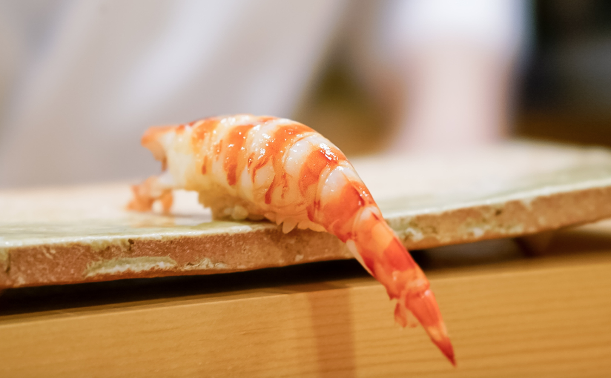 This two-star Michelin restaurant is a stones throw from the iconic Tokyo Tower, and the entrance is typical of top-class sushi place, with little signage and an unassuming traditional wooden Japanese facade. My visit to Amamoto was in the first two weeks of my semester in Japan, but the memory of how good the sushi was always stuck with me. Chef Masamichi Amamoto doesn’t speak much English, just enough to describe what he is serving, but regardless he seems like one of the jolliest people I have ever seen. He is a far cry from the stereotyped surly Chef you would think of in high-end dining. Even when you leave the restaurant, Amamoto shuffles out from behind the counter to shake your hand before you exit. As for the details of the food, Amamoto is known for his signature shrimp nigiri, which he dangles off the counter (pictured). This piece is delicious, as are the various other sushi pieces served throughout the meal… even the shirako (fish sperm sacks)! LINK: (https://tabelog.com/en/tokyo/A1314/A131401/13196420/)