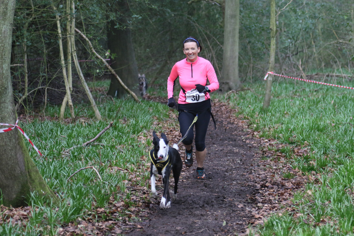 Cate running with Flynn in the Canine Cross