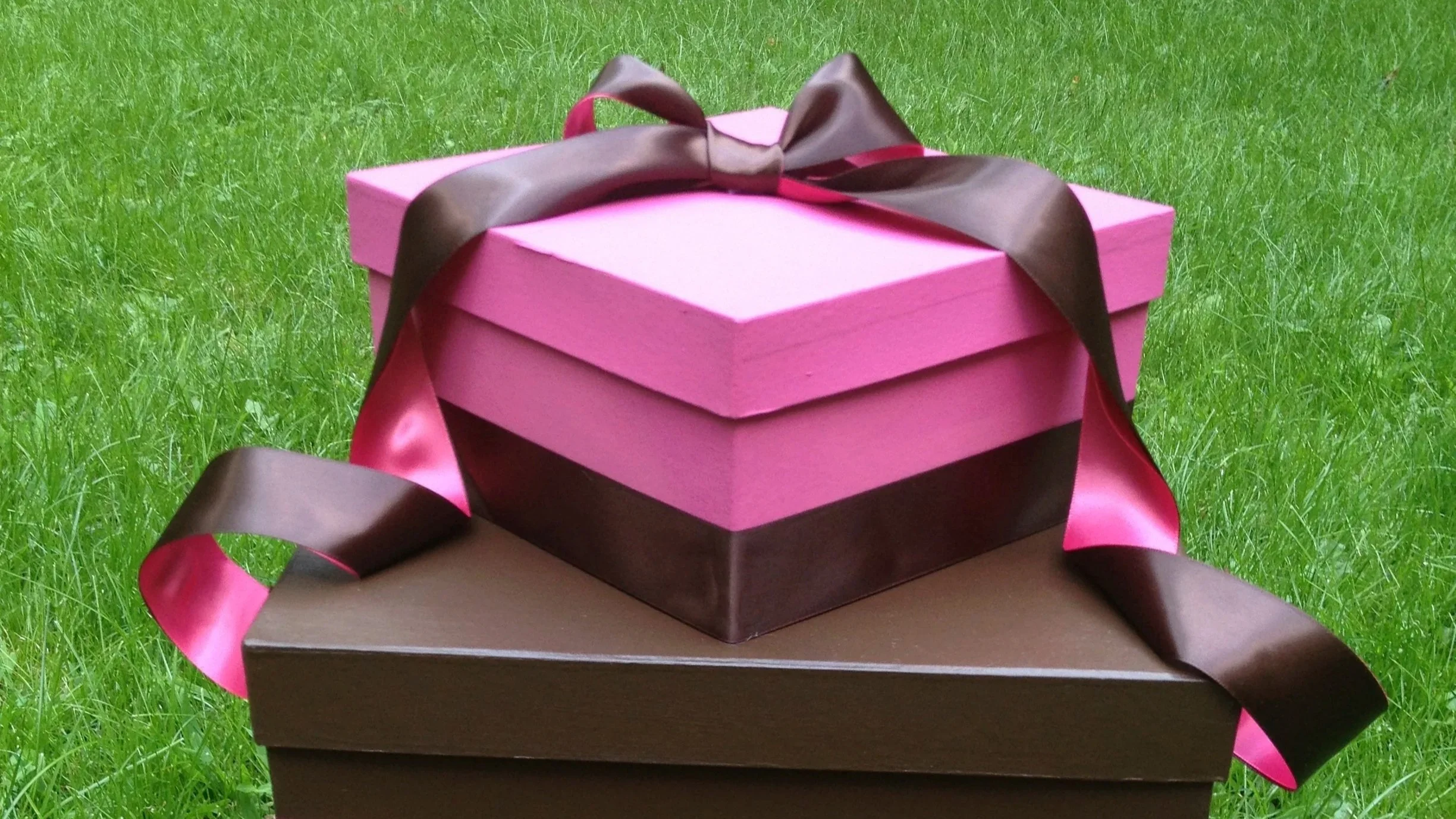 A modern backyard with a swimming pool, white lounge chairs, and a patio area with a cushioned seating area and dining tables, surrounded by desert landscaping including agave plants, lavender, desert bushes, and trees.