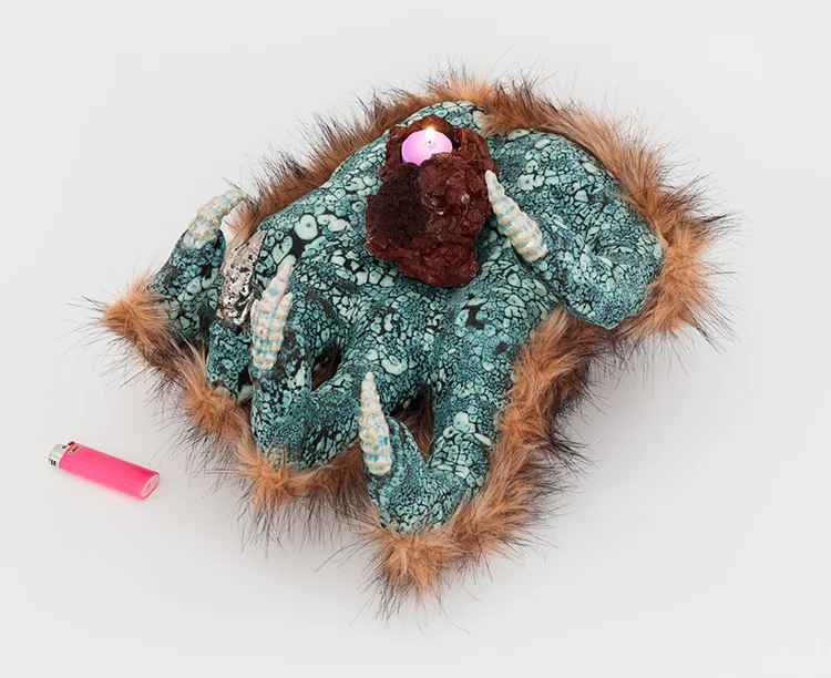 Lava Hand , 2018; Media: Ceramic, faux fur, glaze, luster, lava rock, candle; 17 x 11 x 12 inches