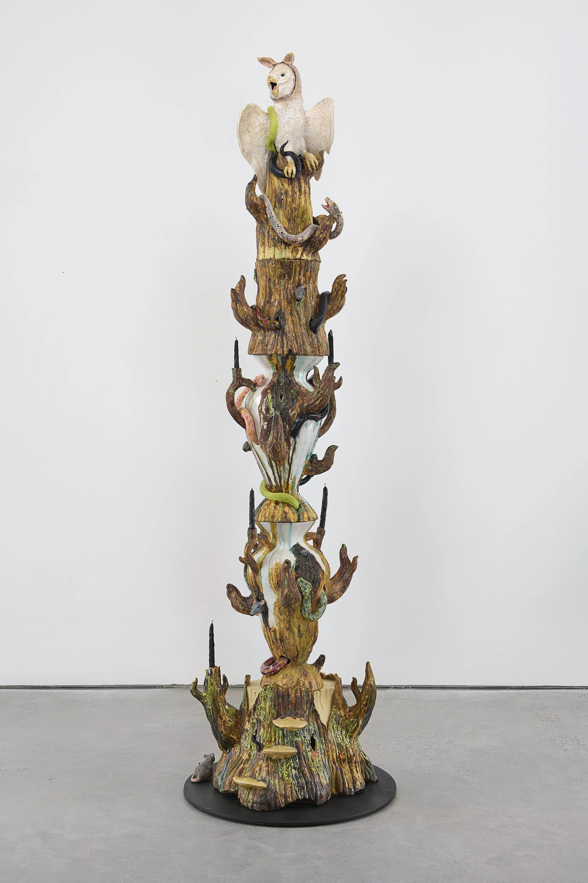   Owl Candelabra  2025; Ceramic, glaze, underglaze, luster, carved black candles, steel base; 94 × 28 × 28 inches 