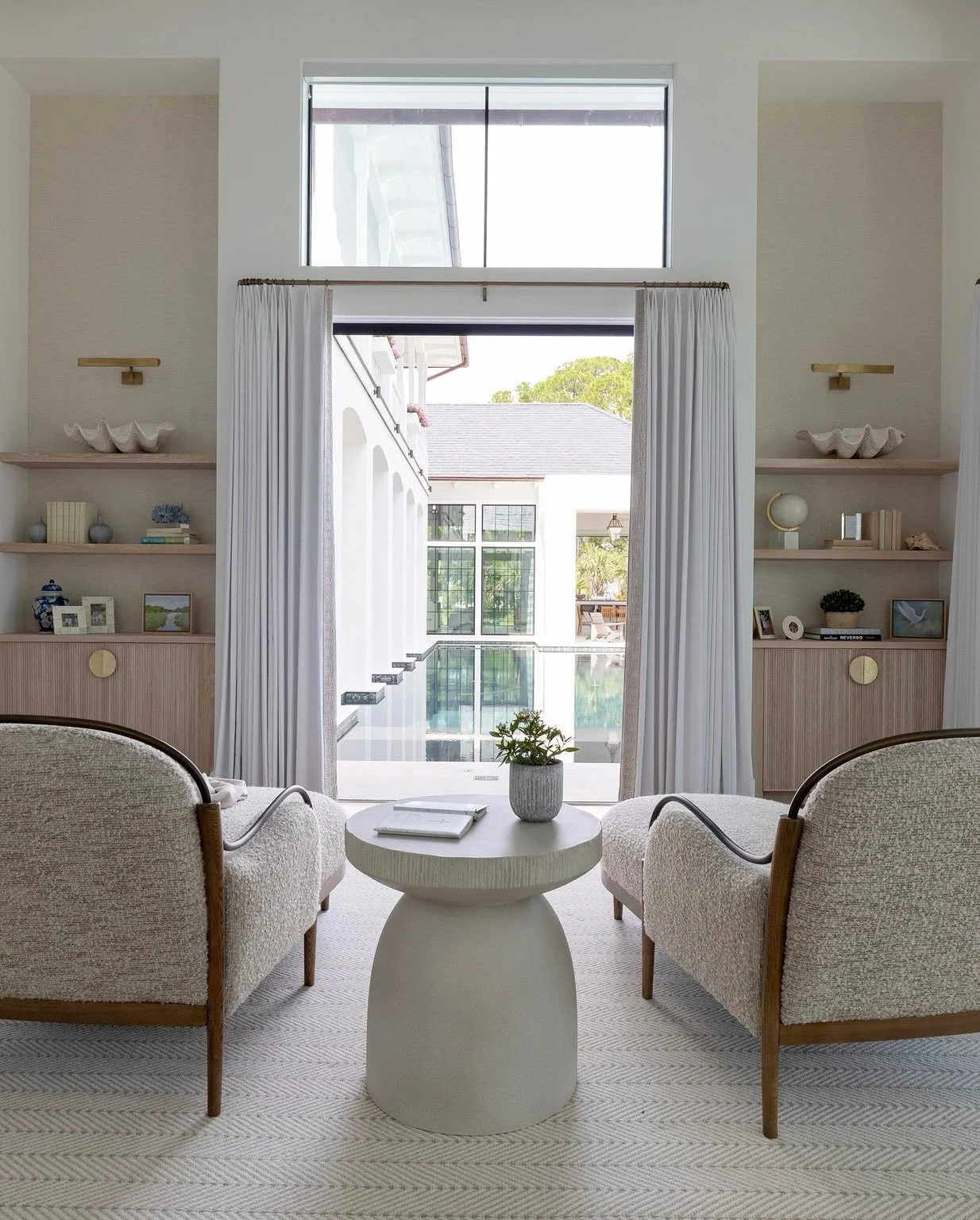 Every element of this primary bedroom and en suite was designed to honor the views beyond the walls. Soft textures, tones, and lines to reflect the beauty of the bay. #primarysuite #interiordesign #bayhouse