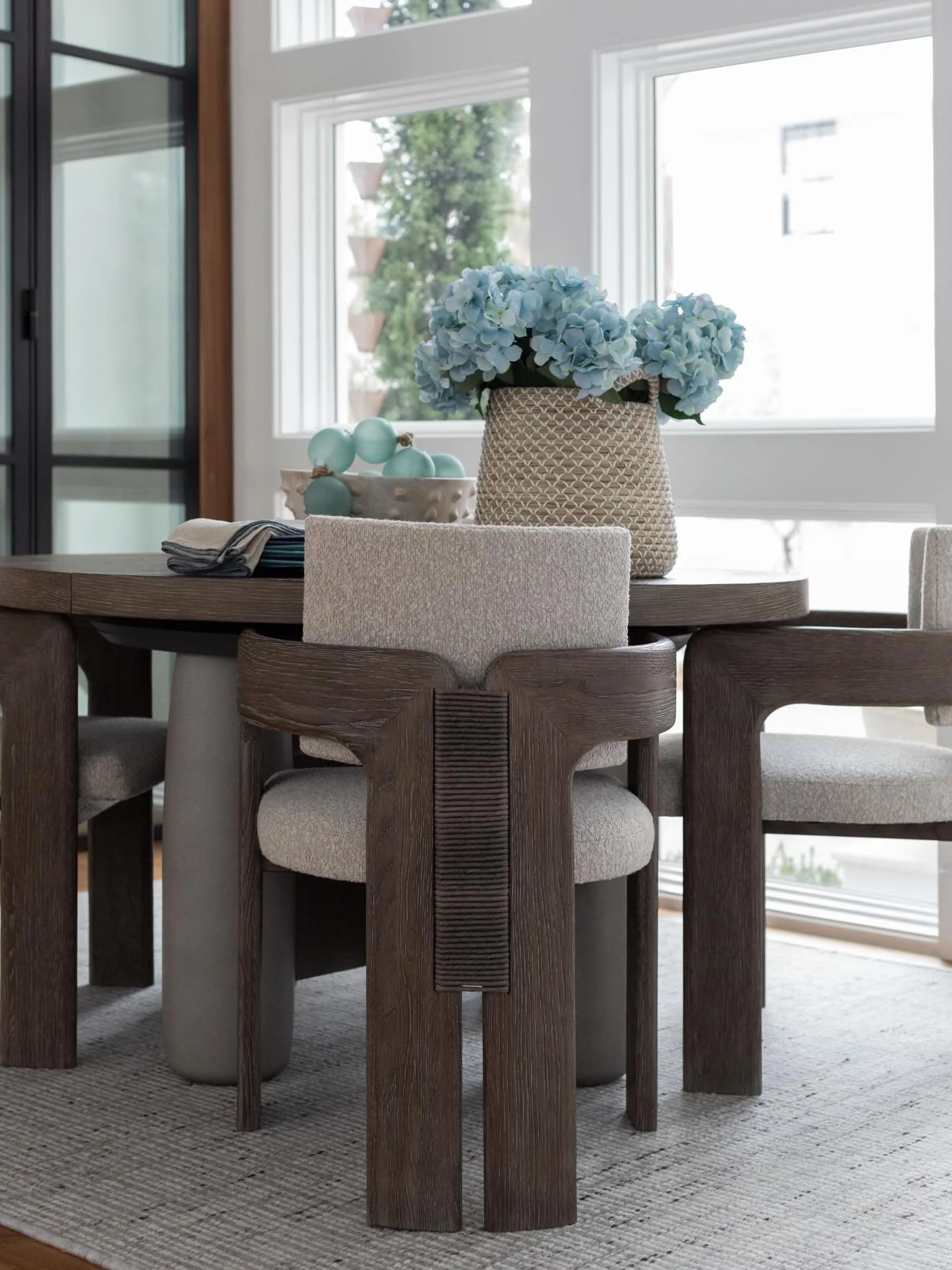 This round table and chairs are from @bernhardtfurniture ✨ The glass room was intended for wine storage, but since my clients do not drink, we transformed it into a cozy little reading nook. 📚