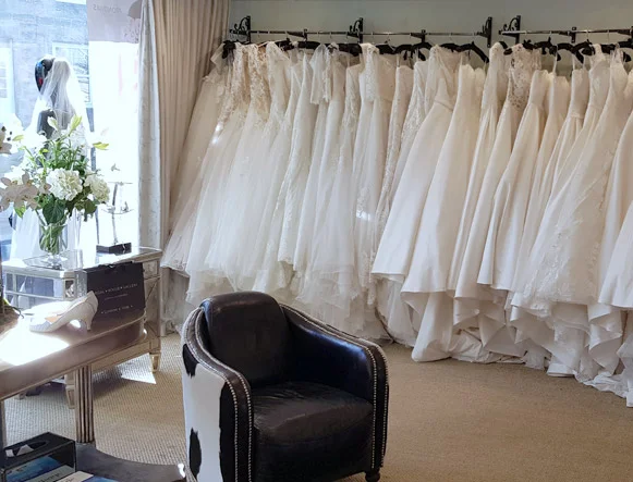 Our front room has a selection of accessories scattered throughout as well as three large rails of our beautiful bridal gowns. There are two comfortable seats for your guests to sink into while you try on dresses behind the luxurious draped curtains.