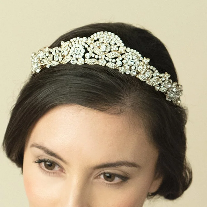 Marcella is adorned with solitaire and baguette cut stones forming an Art Deco pattern of stylized flowers and leaves.