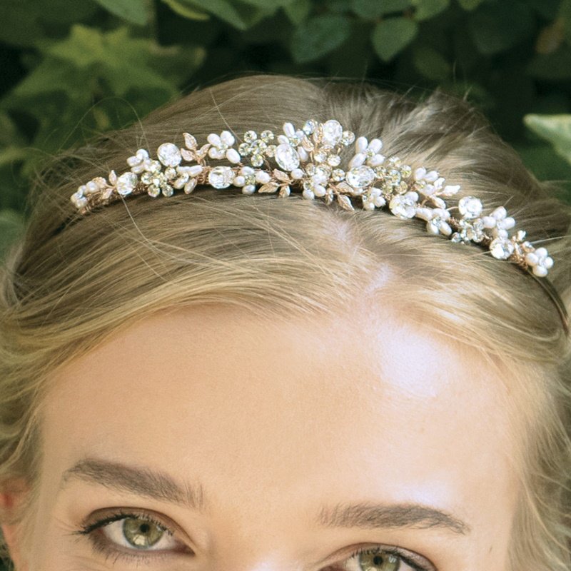 Desire by Ivory & Co is a gorgeous tiara created using cut solitaire stones set in floral patterns accented by large oval cut stones, delicate silver leaves and tiny ivory freshwater pearls.