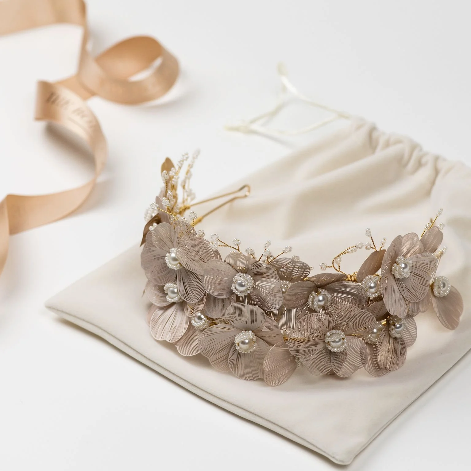 A beautiful hand crafted floral bridal crown made with enamel flowers embellished with pearls and tiny pearl beads.