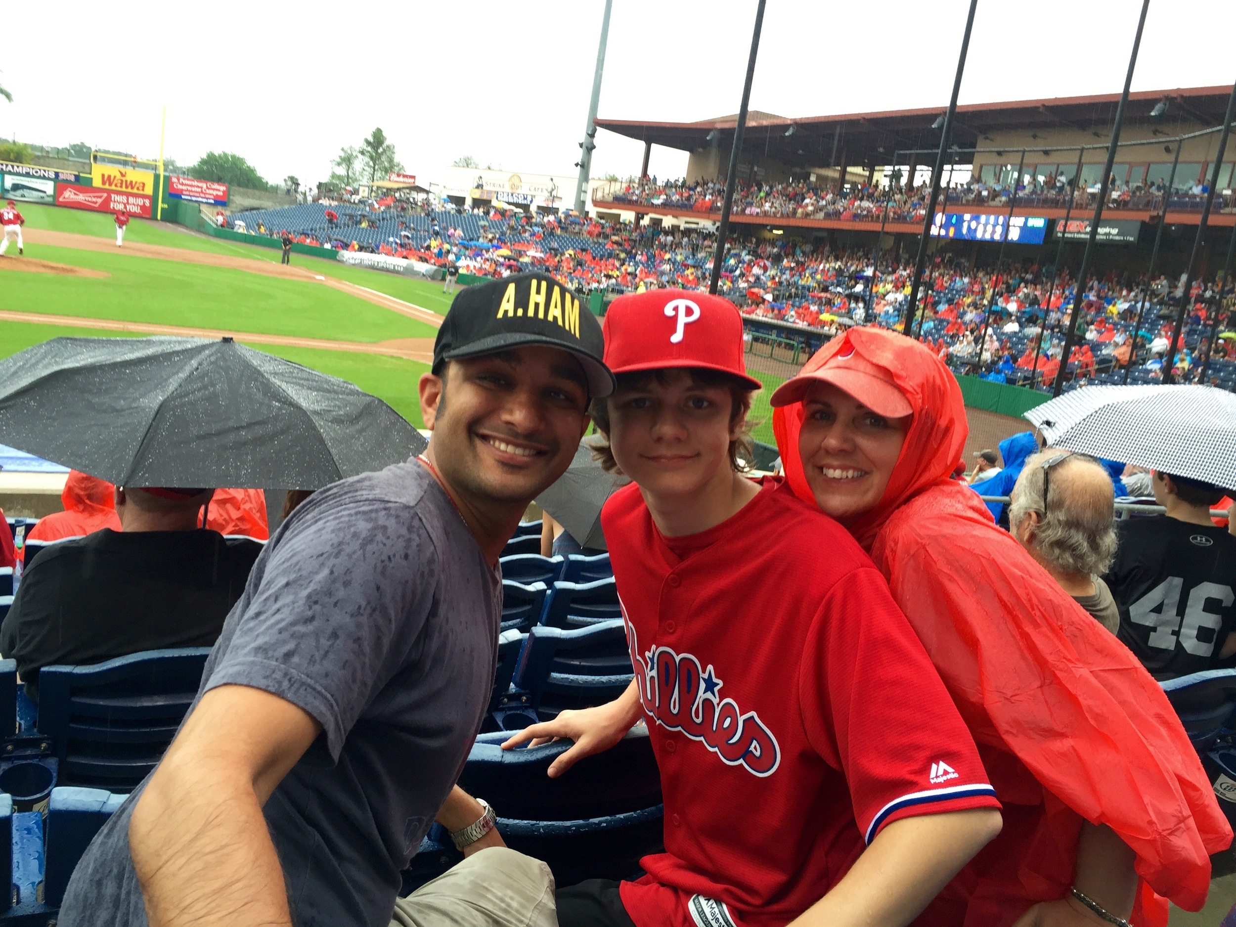 Ty, Muneesh and Monique enjoying a rain soaked Phillies game