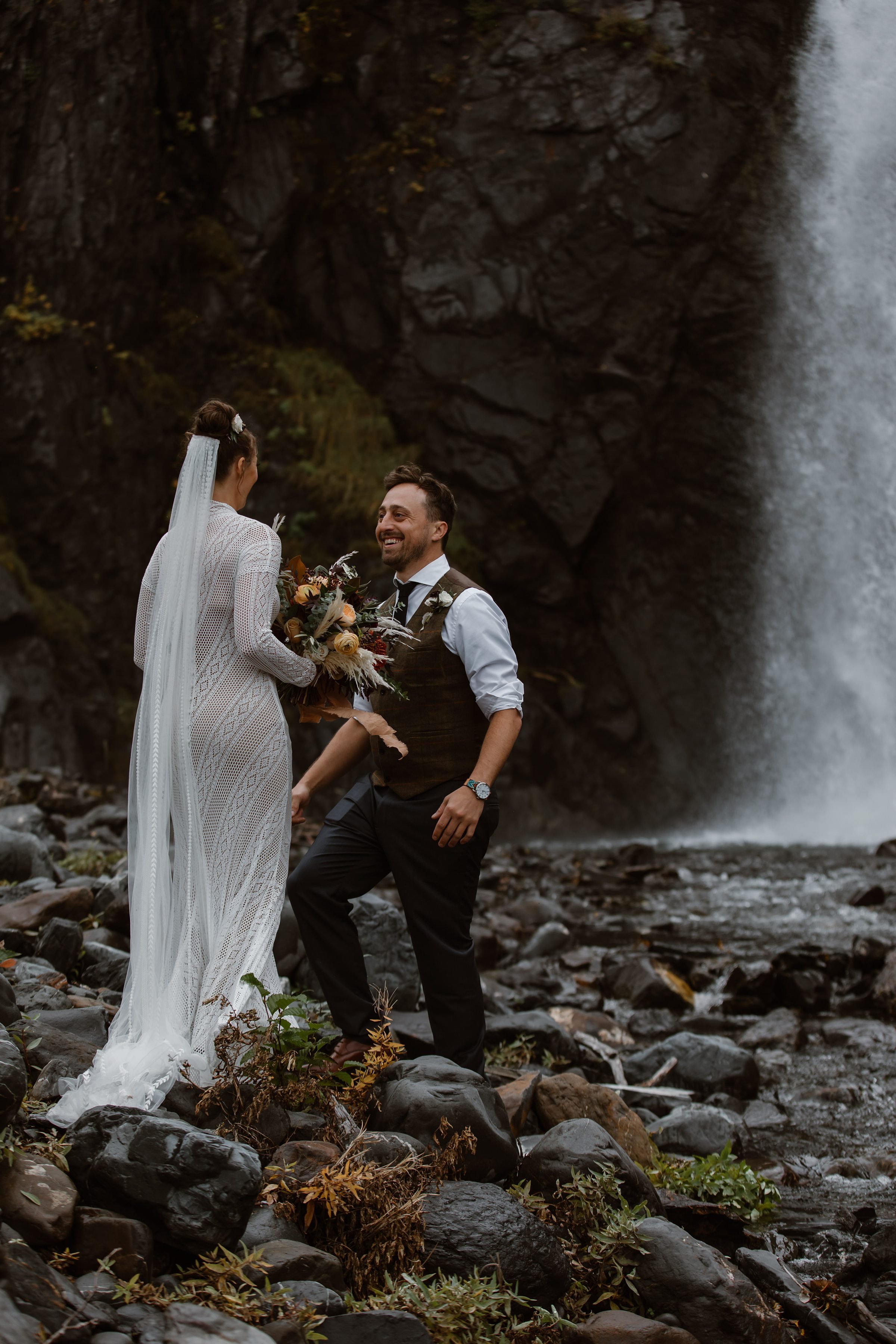  bride and groom first look by a waterfall 