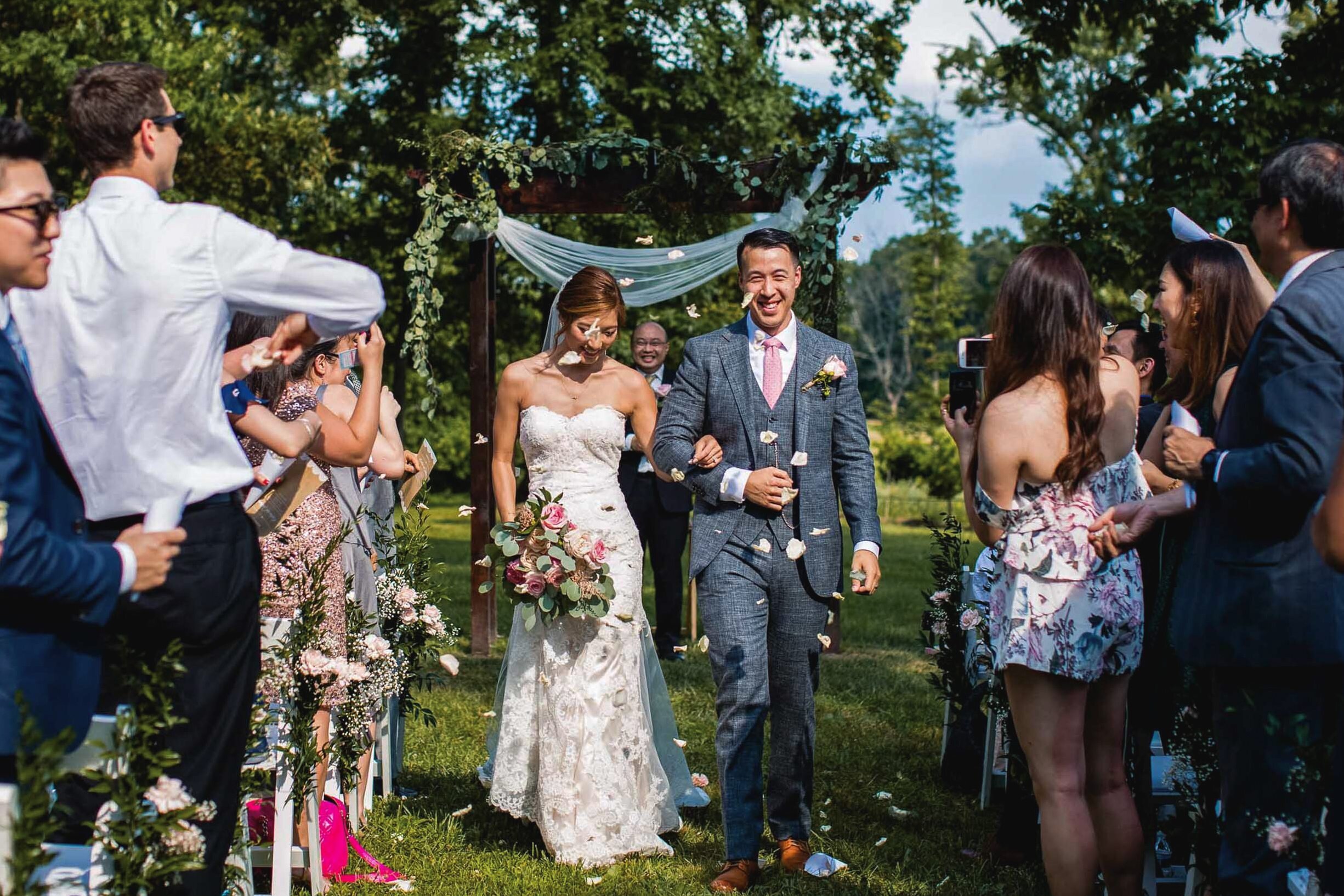 bride-groom-after-ceremony-aisle-flower-toss.jpg