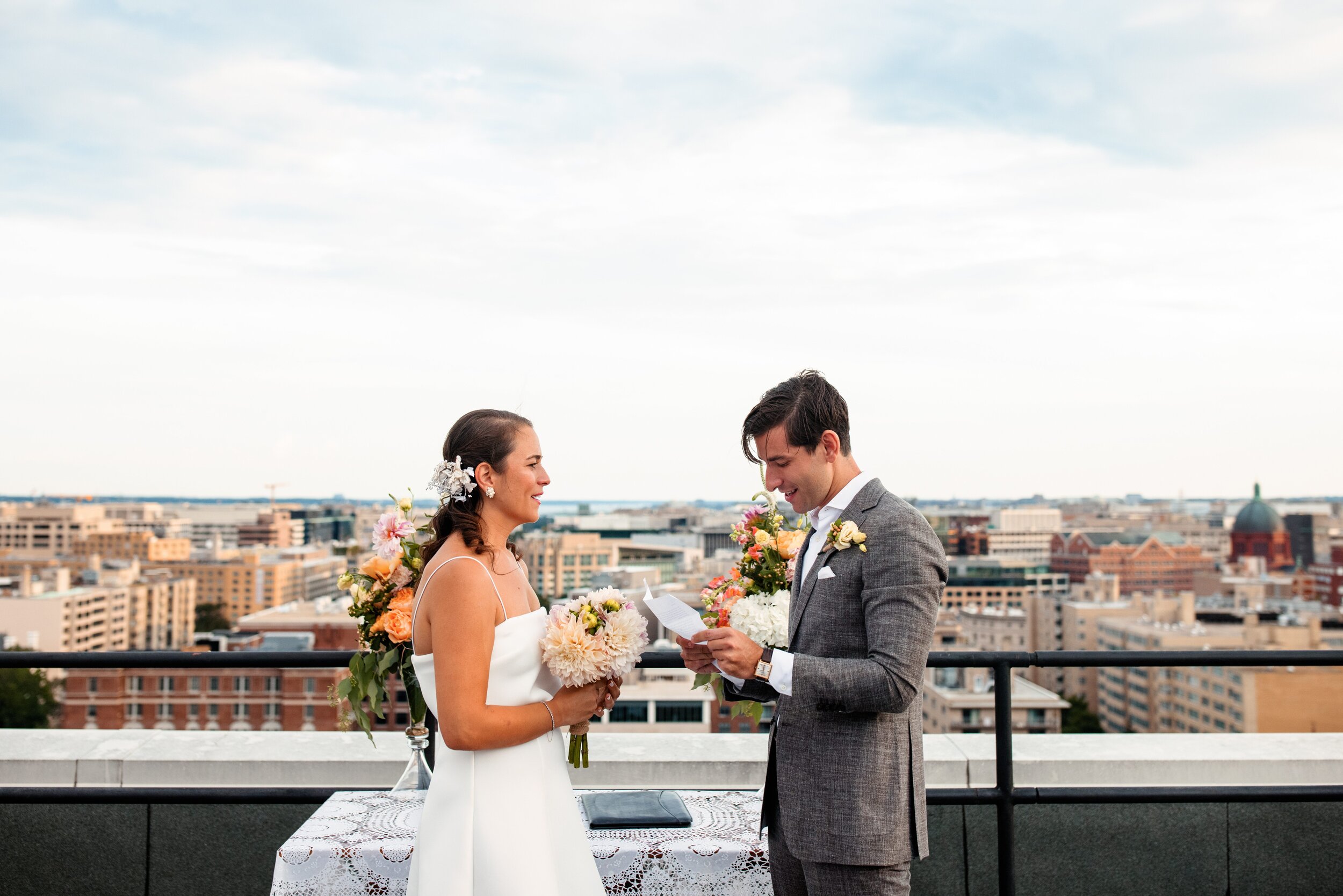 bride-groom-saying-vows-at-rooftop-wedding-ceremony-washington-dc.jpg