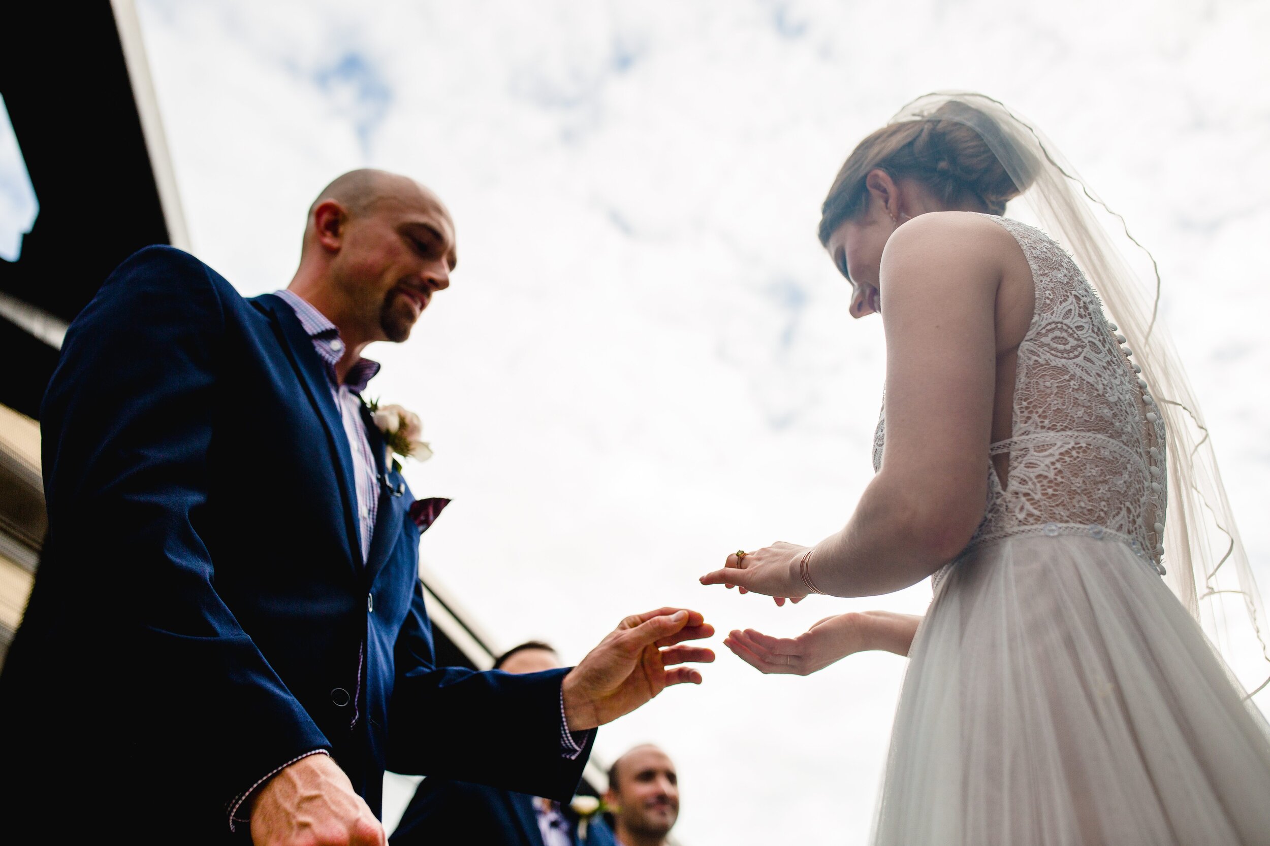 bride-putting-ring-on-groom-hand.jpg