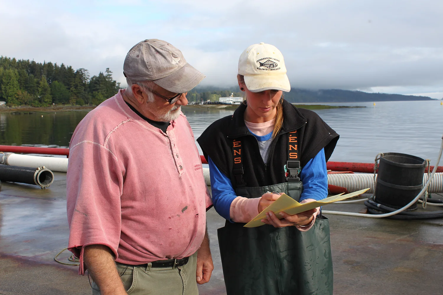An IPHC port sampler interviews a wild Pacific halibut vessel master following a fishing trip.