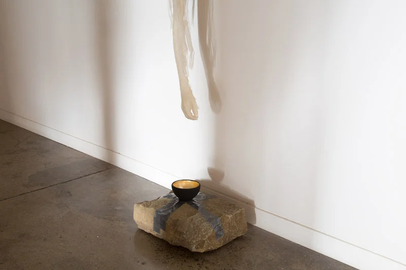 Alchemy, 2014, sandstone rock, beaten lead, ceramic bowl treated with gold leaf,