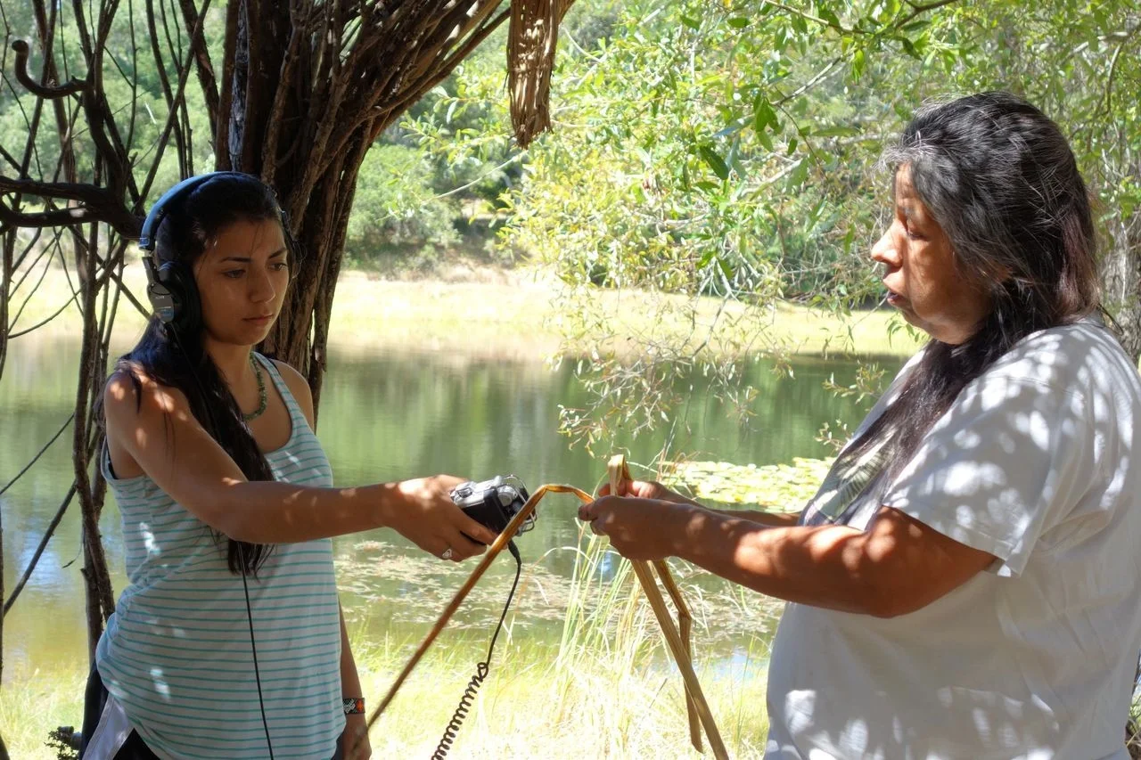A young participant of one of our internships interviews a Native Californian Maidu elder about Tule reed weaving.