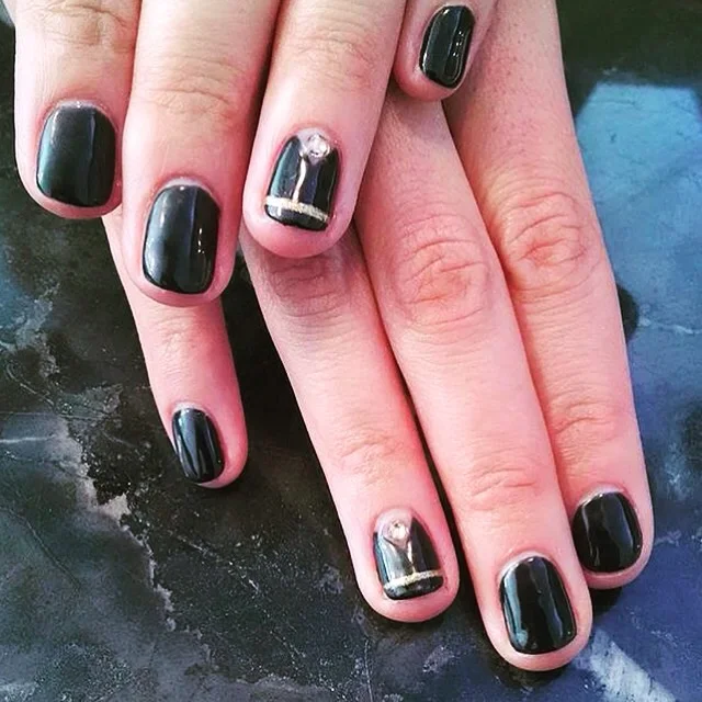 Gold pinstripes, negative space and Swarovski crystal nail design