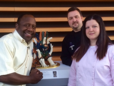 Ashley Joslin & John Joslin along with Fox 8's Kenny Crumpton at CMA's 100th Celebration featuring Ashley's "Tomb Guardian" Cake.