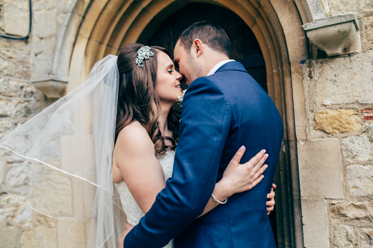 "From the moment Naomi walked in the door and greeted me with a great big smile and hug it felt like she was a member of the wedding party itself and that I had known her for years! For myself and my now husband, we have never been a fan of having our photos taken so the thought of being the centre of attention and having a camera stuck in our face was our idea of hell – however with Naomi this was not the case. She instantly made us feel totally relaxed when having our photos taken (be it just the 2 of us or the obligatory group shots) and I can honestly say she made the whole experience painless and fun! Naomi is such a warm and bubbly person and it just so happens she takes awesome photos too! When we received the USB stick containing all of the images and the link to the site where we could view the photos we were completely blown away with the quality and how much of the day she captured. Every time we look back at the photos we can really relive the day and remember all the warm gushy feelings and how much fun our guests had. Naomi not only captured the image but had also managed to capture the essence of our wedding perfectly! The little touches go a long way and the way in which the USB and a sample of photos were sent to us in a personalised wooden box branded with Naomi’s logo made my day! It was such a lovely item to receive and I was not expecting it – the presentation was incredible and was just another reminder of how professional and what attention to detail Naomi has. The whole process from initially contacting Naomi in the build up to the wedding right through to after the day itself has been so easy and stress free and I will certainly be recommending her to all my friends and family! Thank you Naomi for playing such an important part in our special day. Through your photos we can always look back on our wedding day and cherish every moment of it! " Kerry + Nick April 2017