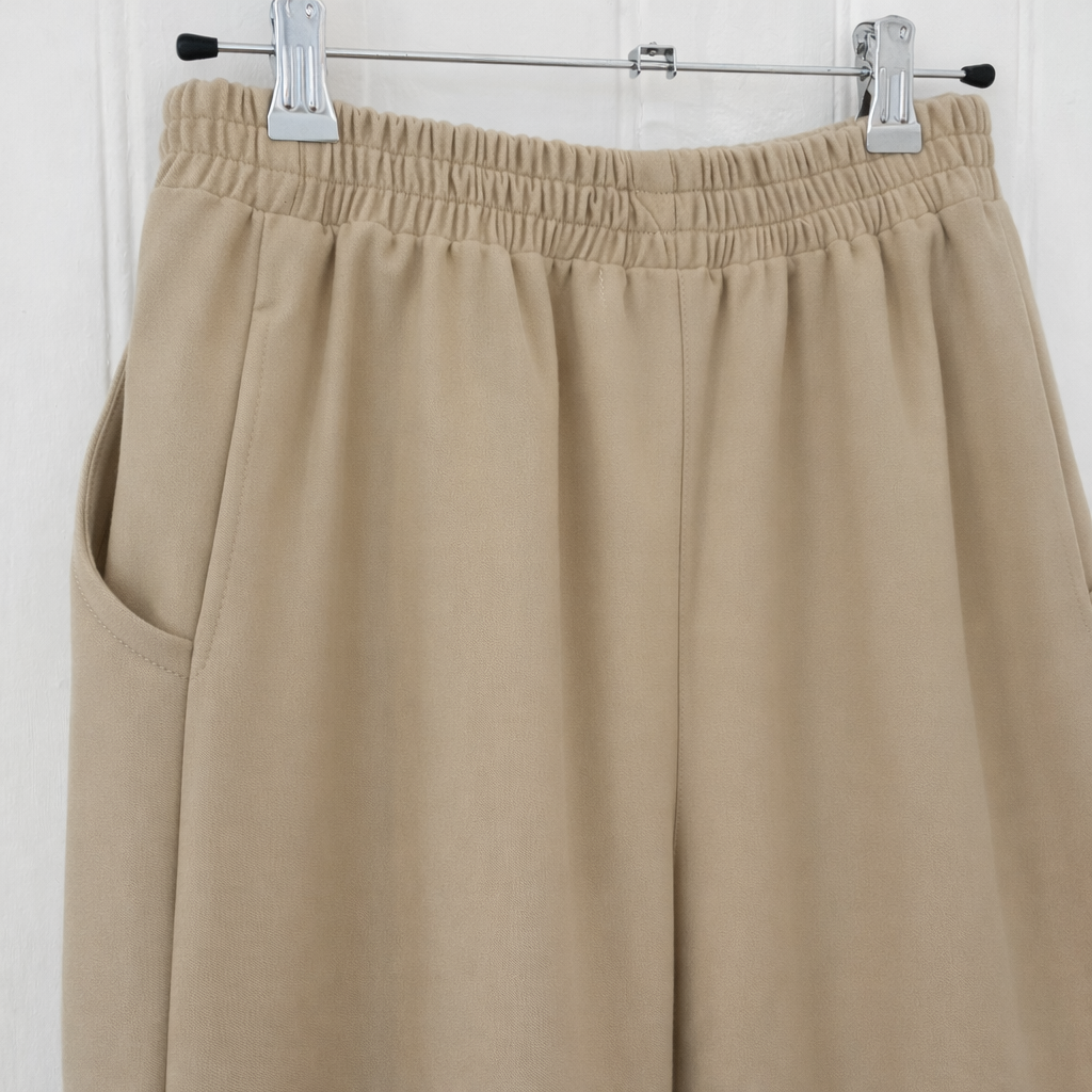 Beige elastic pants on hanger 1.png