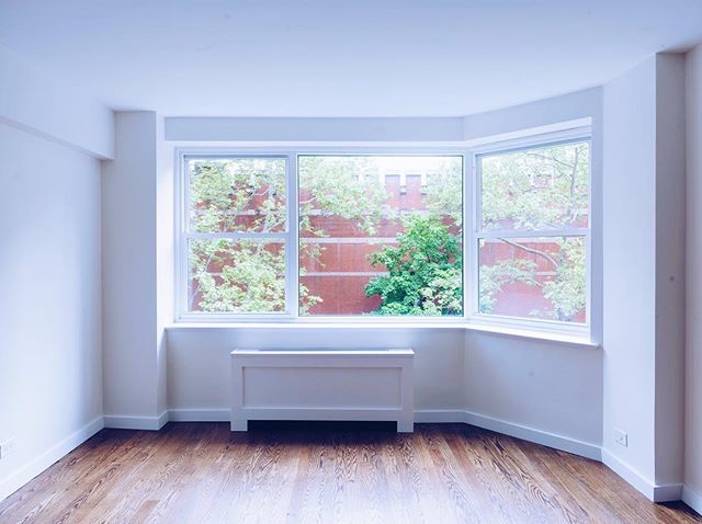 New baseboards, custom radiator cover and a fresh coat of paint goes a long way. Upper East Side condo facelift.