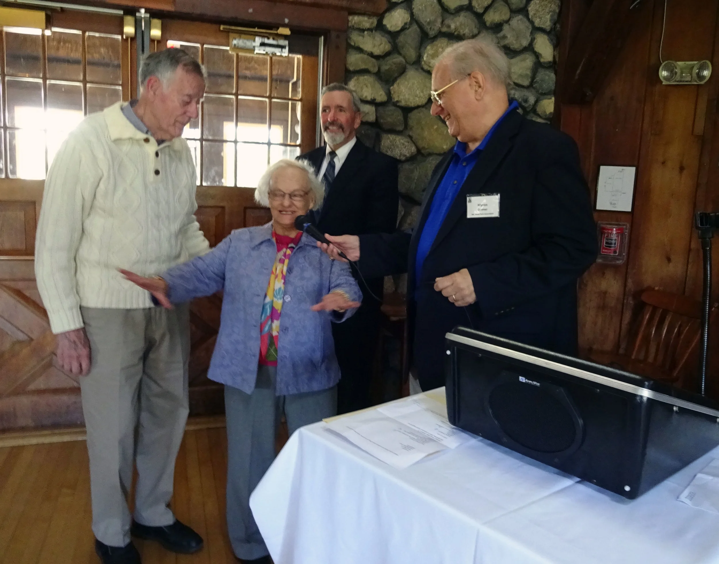 Joe and Patricia Doucett being introduced by Association president Myron Dittmer, noting that they were married at the clubhouse 61 years ago.