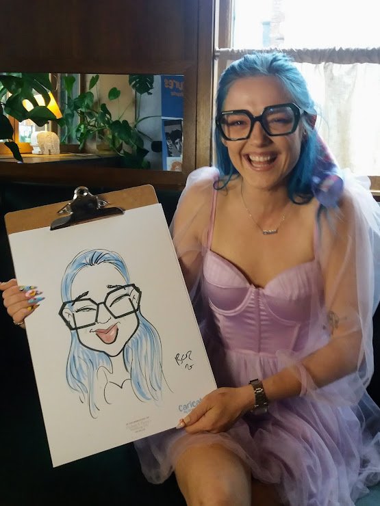 Wedding guests posing with live caricature drawings during drinks reception in Juno, Dublin 