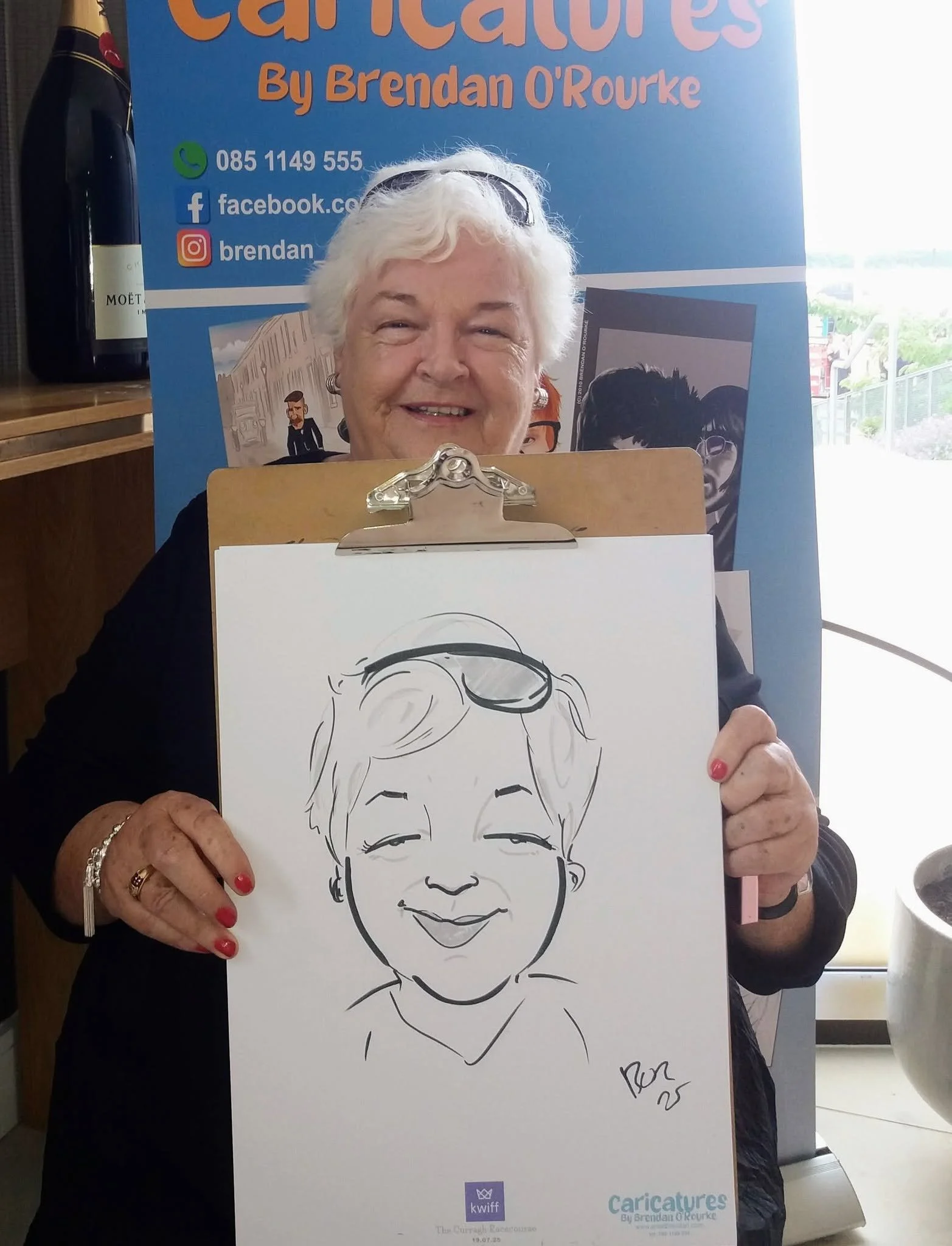 guest holding a finished caricature portrait.