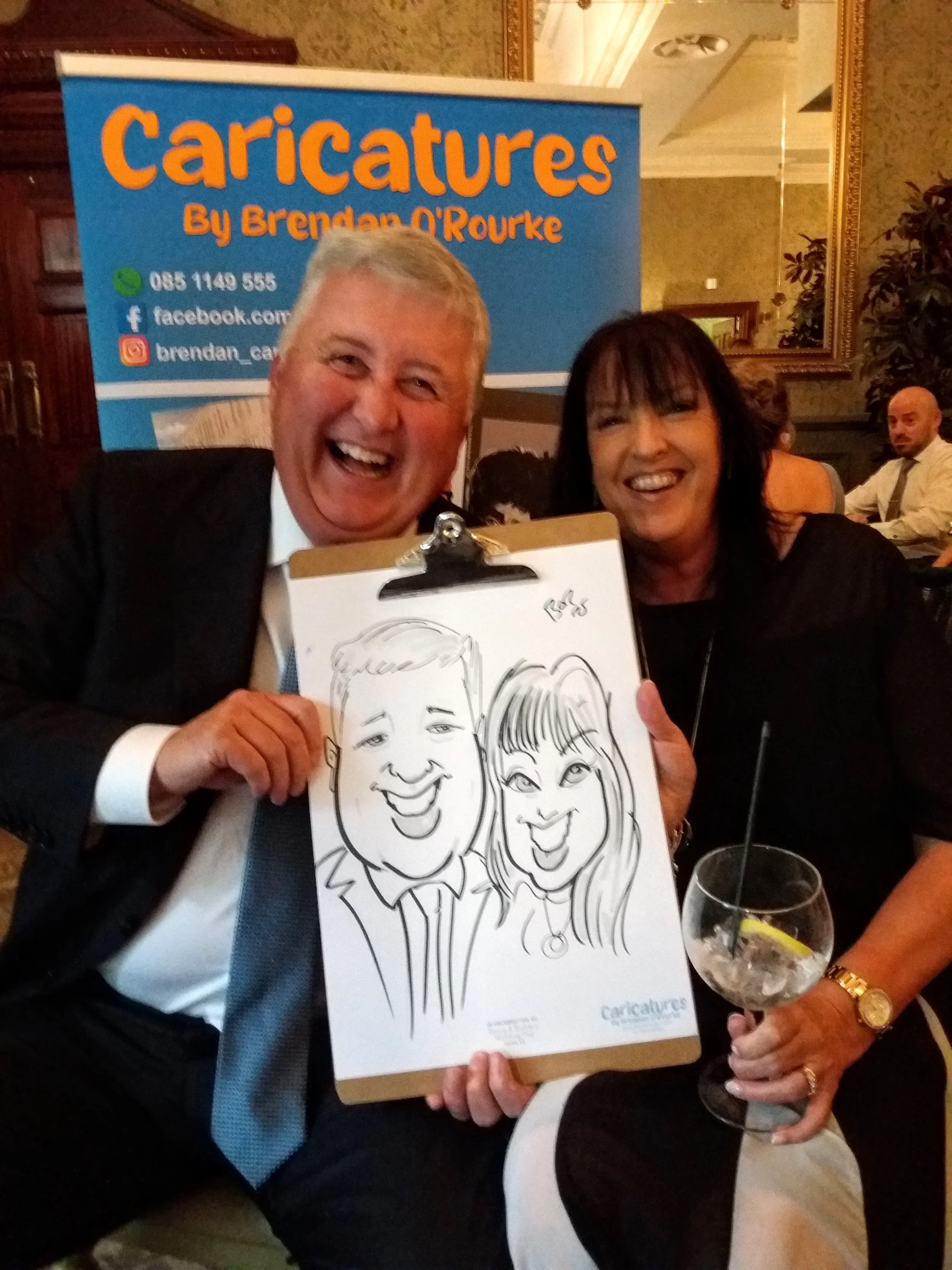 Wedding guests holding their finished caricature portrait drawn live at the reception.
