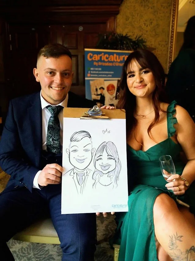 Couple posing with their live caricature portrait at a wedding reception in The Heritage Hotel Killenard.