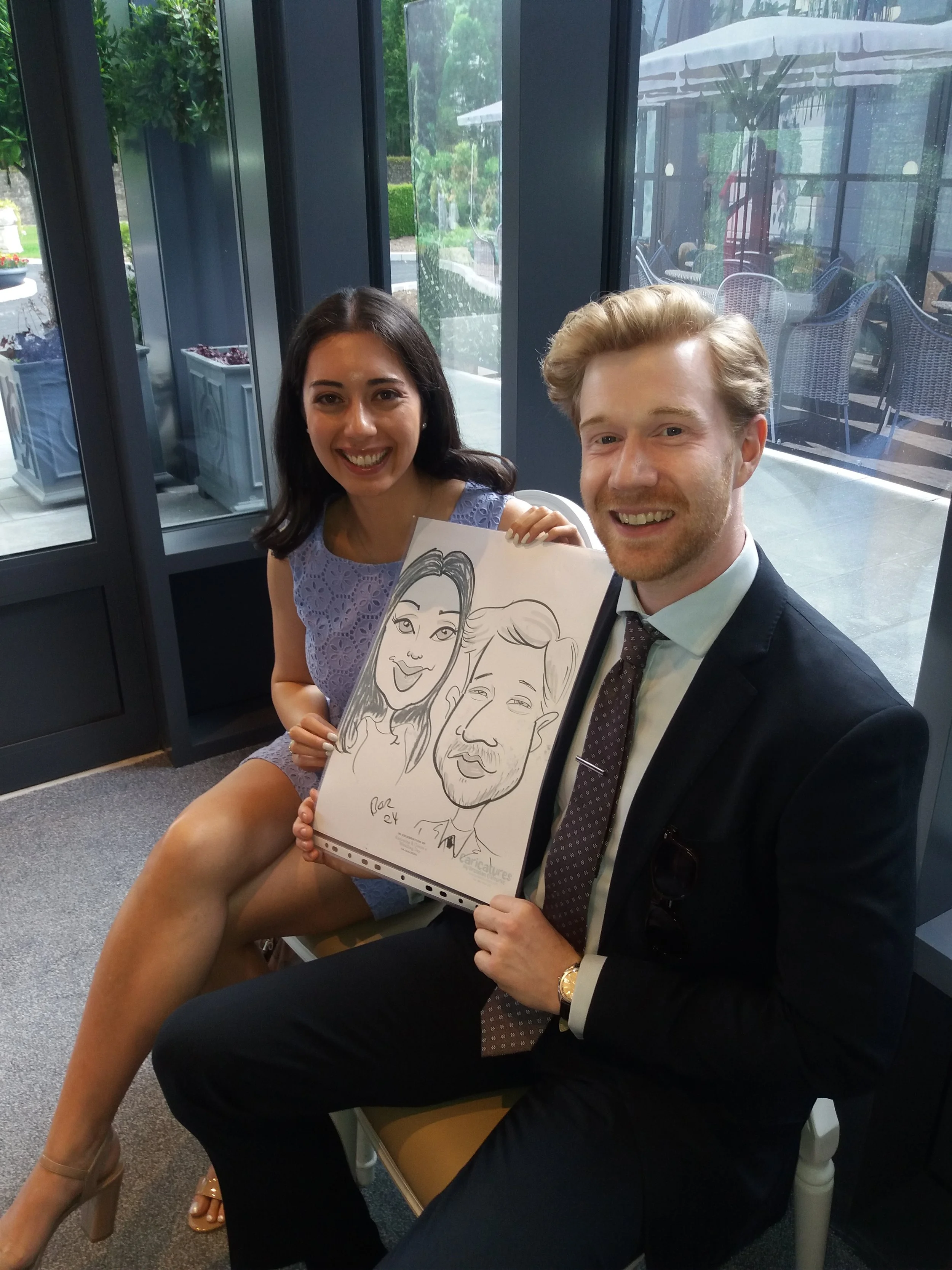 Another happy pair with their caricature keepsake from the wedding