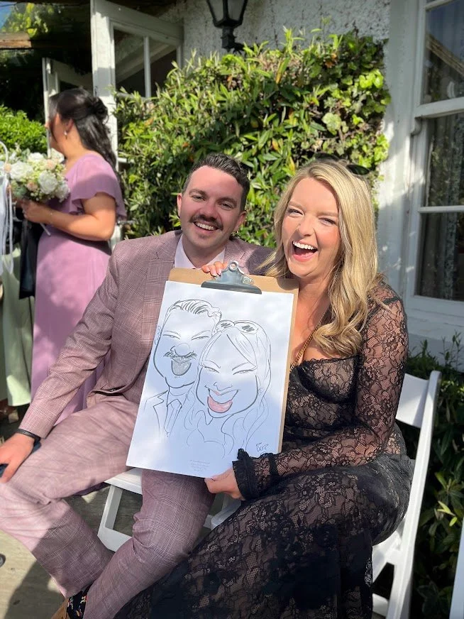couple posing with live caricature draw at a wedding in rathsallagh house, by artist brendan o'rourke
