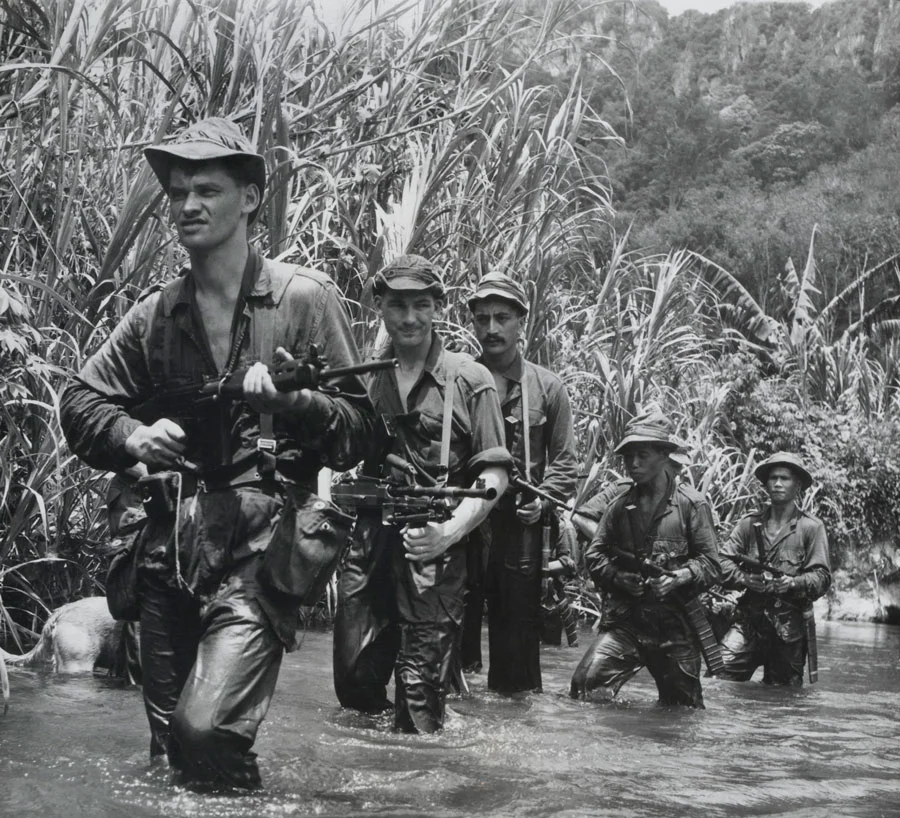 Malay and New Zealander soldiers on a jungle patrol, circa 1957. (Photo: The National Army Museum .)