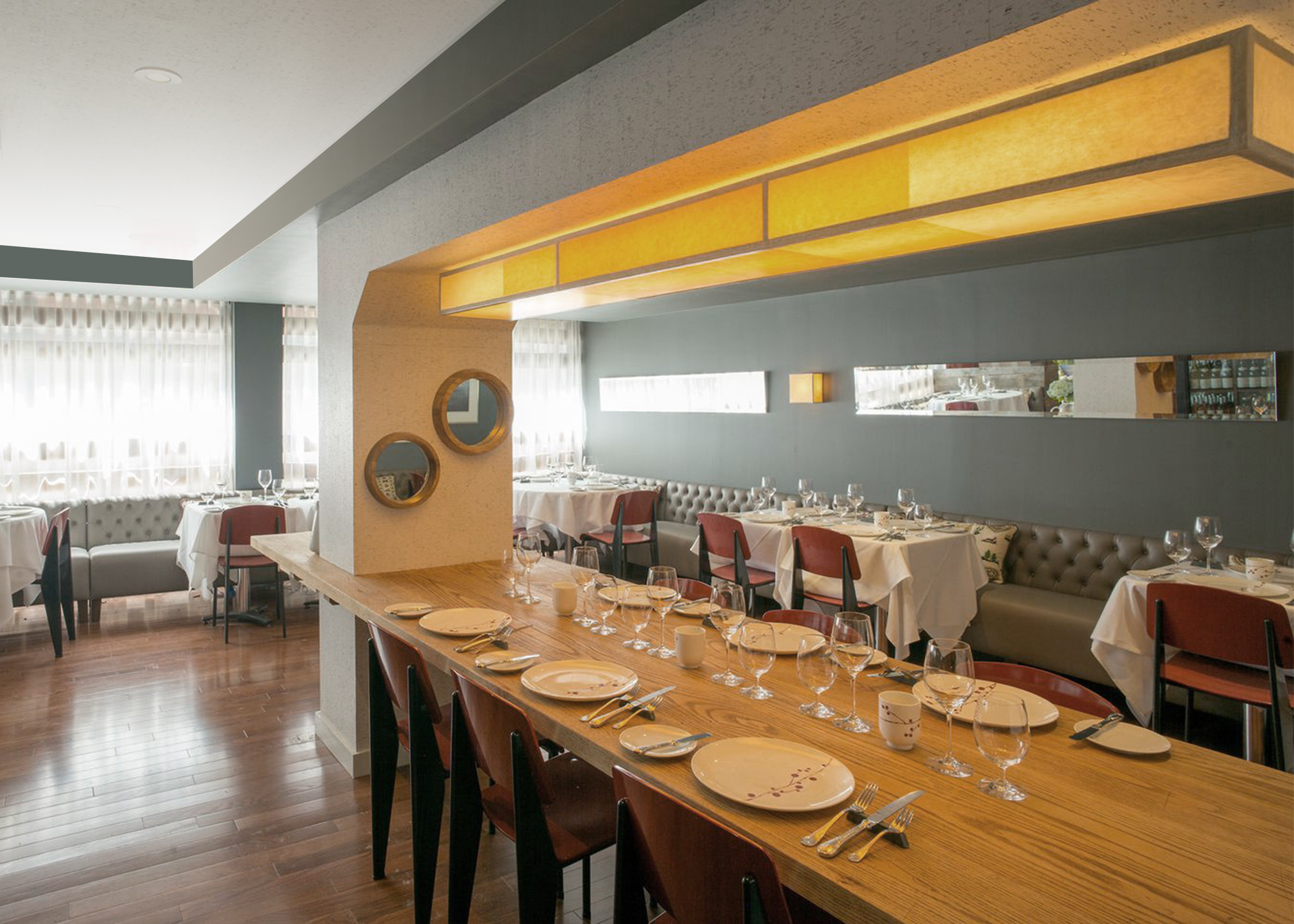 The main dining space was refreshed with a central floating oak farm table, cork wall/ceiling linings and carefully located lighting, mirrors and artwork for an elevated fine dining experience.