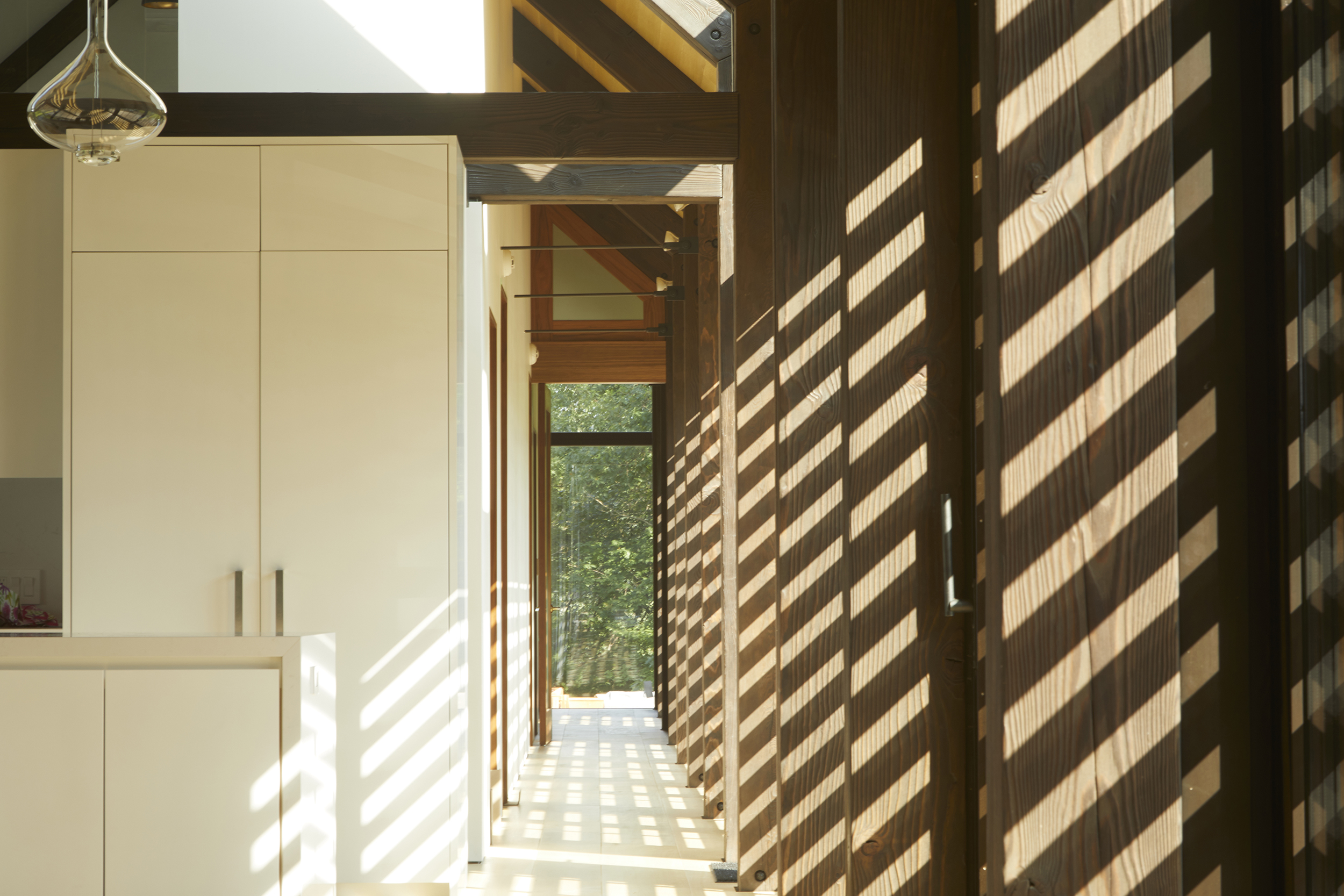 A sun-filled south-facing corridor travels the length of the bedroom wing, acts as a galleria and captures poetic shadowplay throughout the day