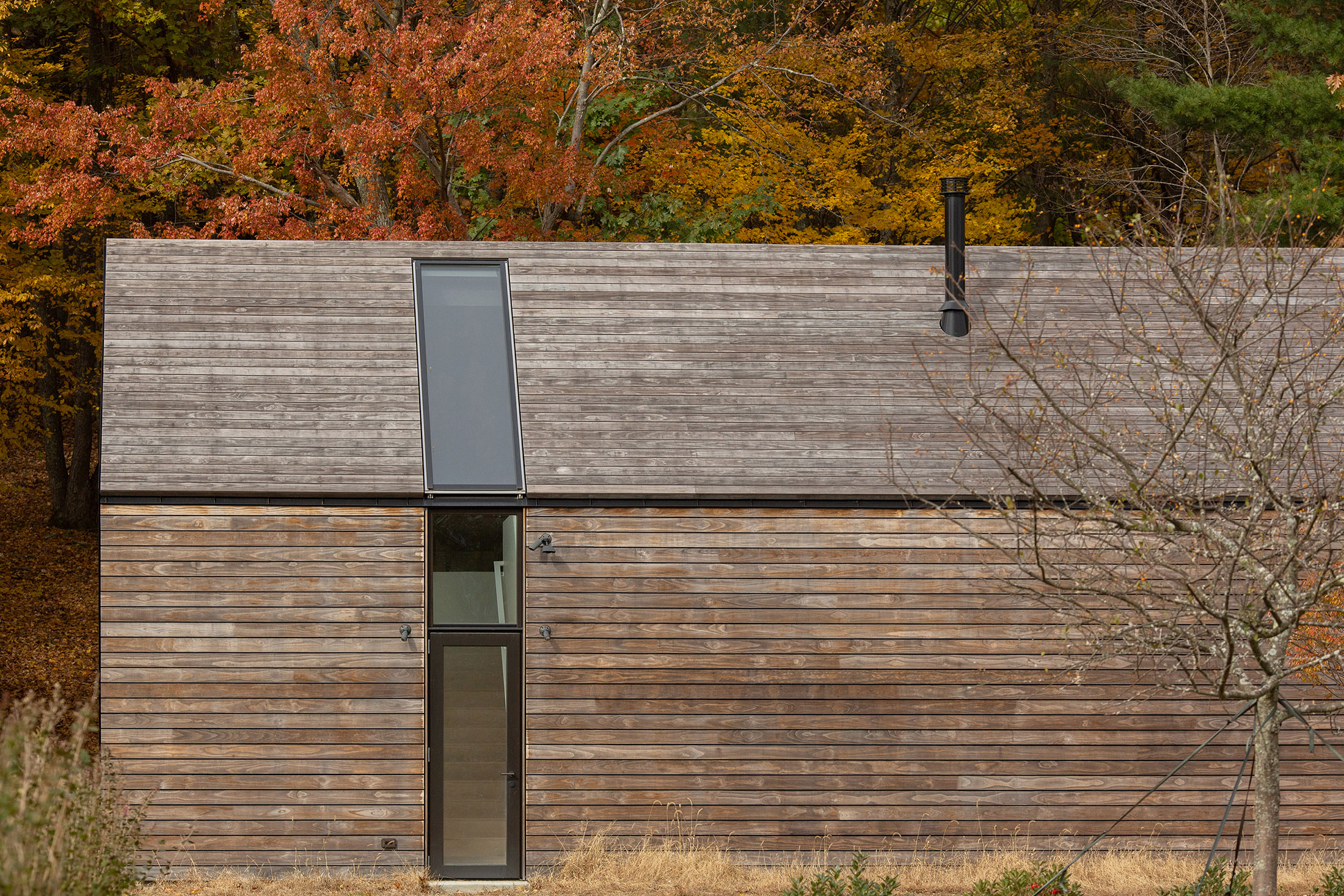 Like the main house the same materials are used for the siding, roofing, and the same design intent for applying a full length skylight above the stairwell