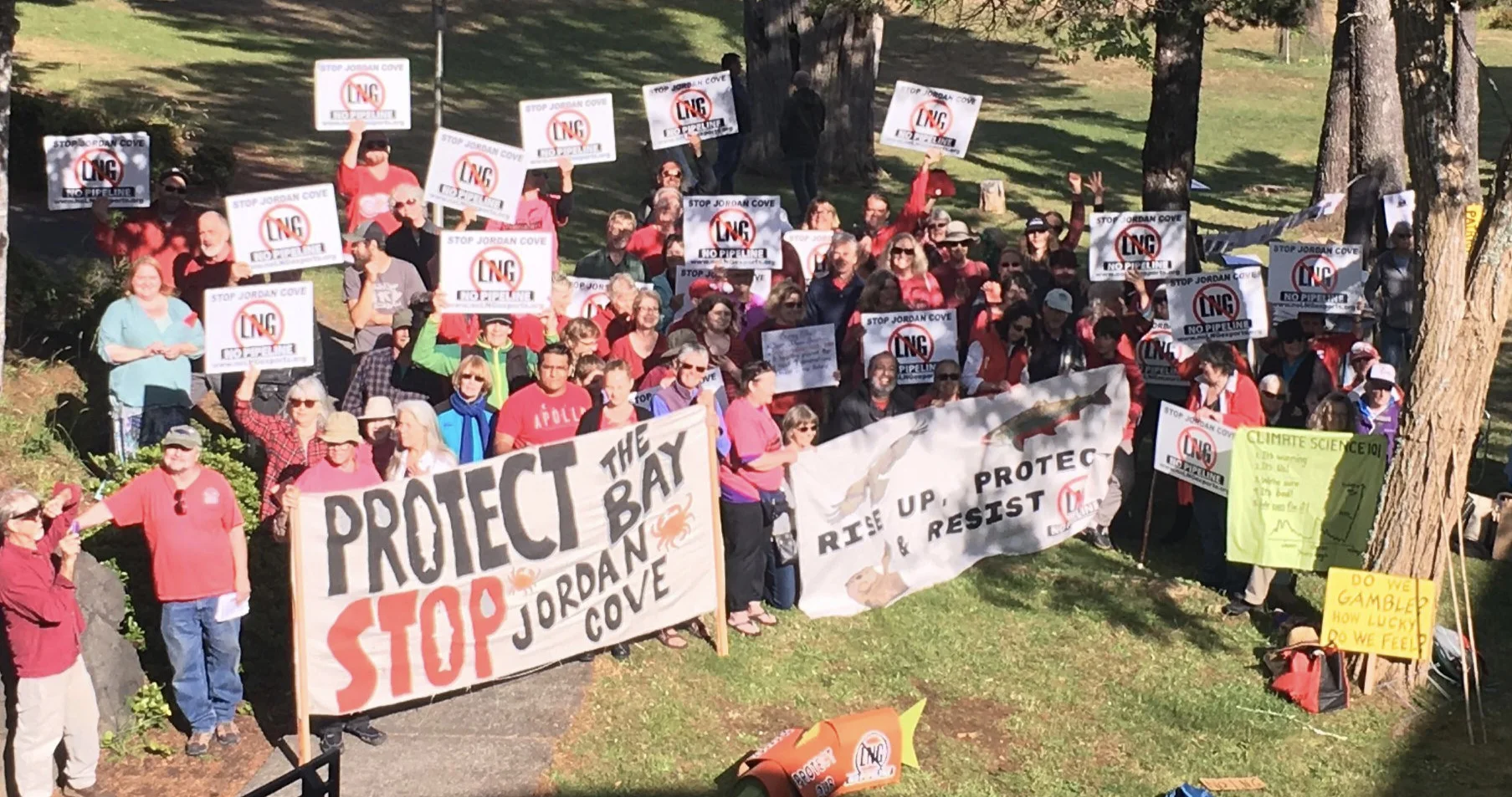 JUne, 2019: people rally outside the ferc hearing in Coos bay, OR to share their concerns about the jordan cove LNG project, sing, and eat cake!