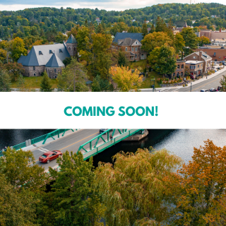 Aerial view of a small town with houses surrounded by trees, a bridge over a river, and a few cars on the road, with a banner that says 'Coming Soon!'