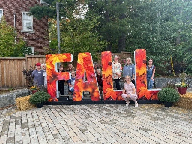 Artists around Fall Sign.jpg