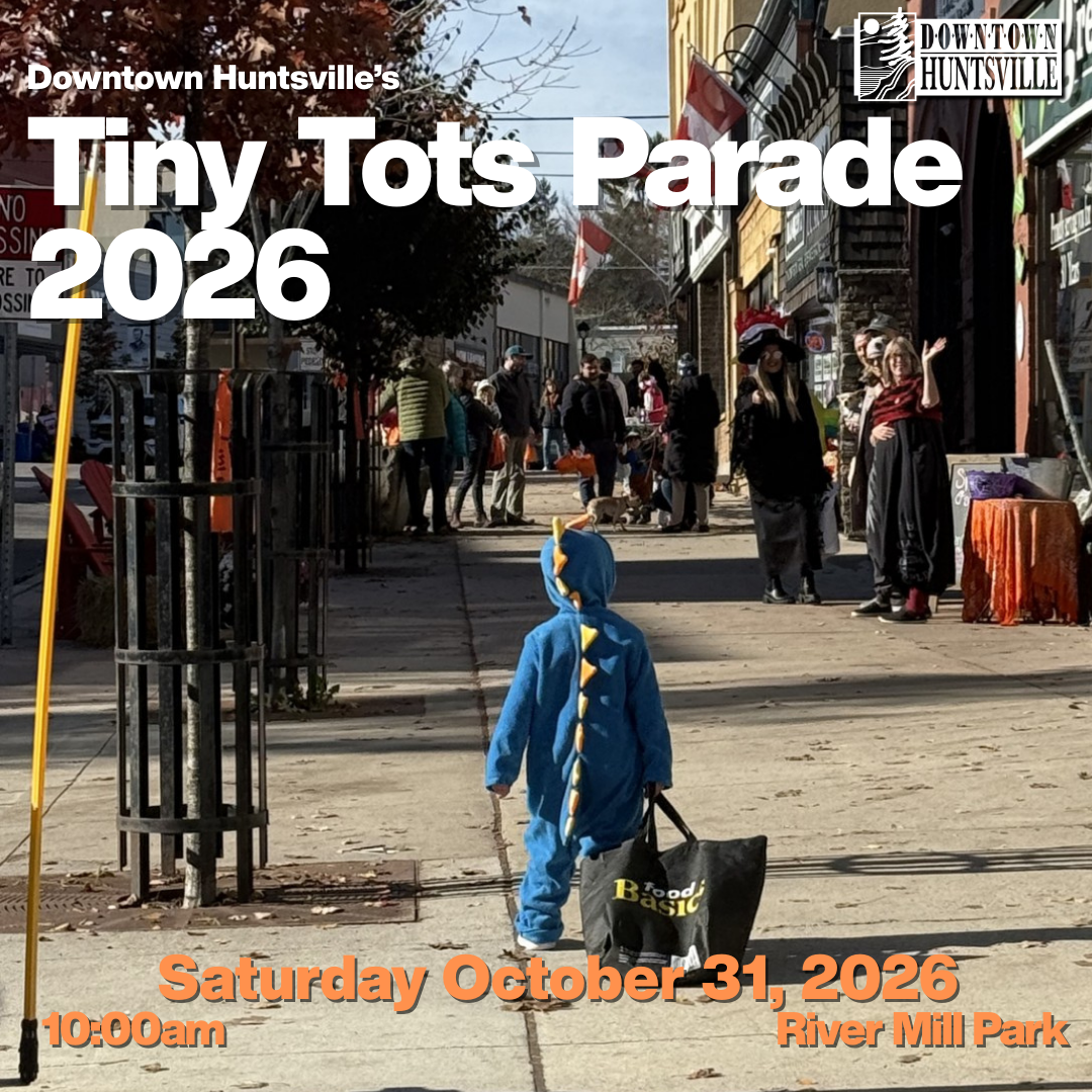 child in dinosaur costime draggin bag of candy down street trick or treating on mains treet huntsville on