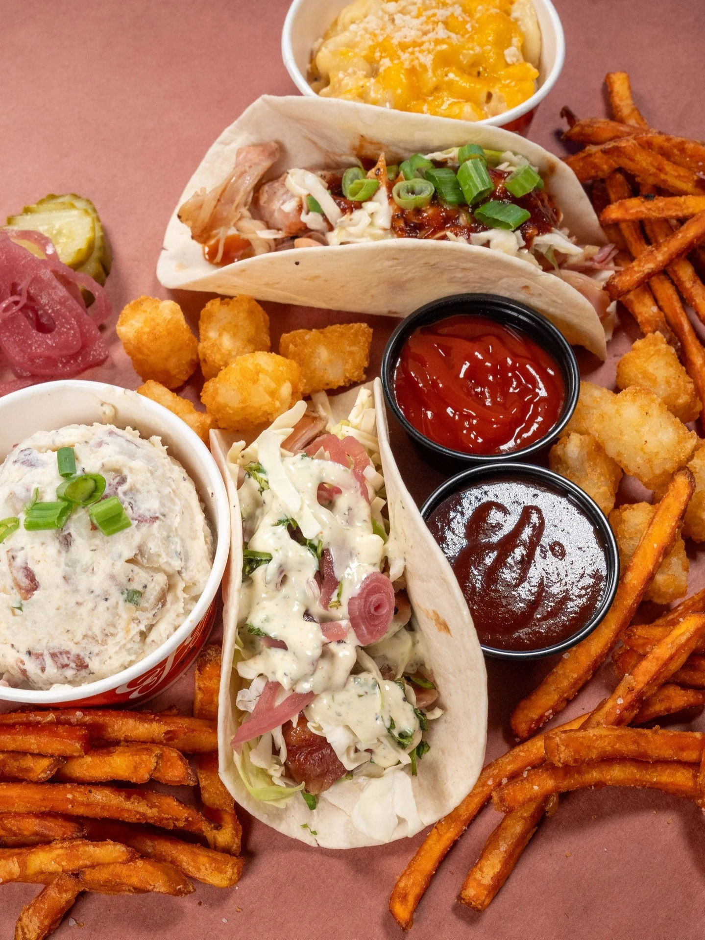 Up close and personal with our Chicken Tacos, served BBQ Style (creamy slaw, green onions, original BBQ sauce) or Ranch Style (cabbage, pickled red onions, cilantro, ranch). 🌮 🌮 

#bbq #feastbbq #chickentacos #choppedchicken #macandcheese #potatosa