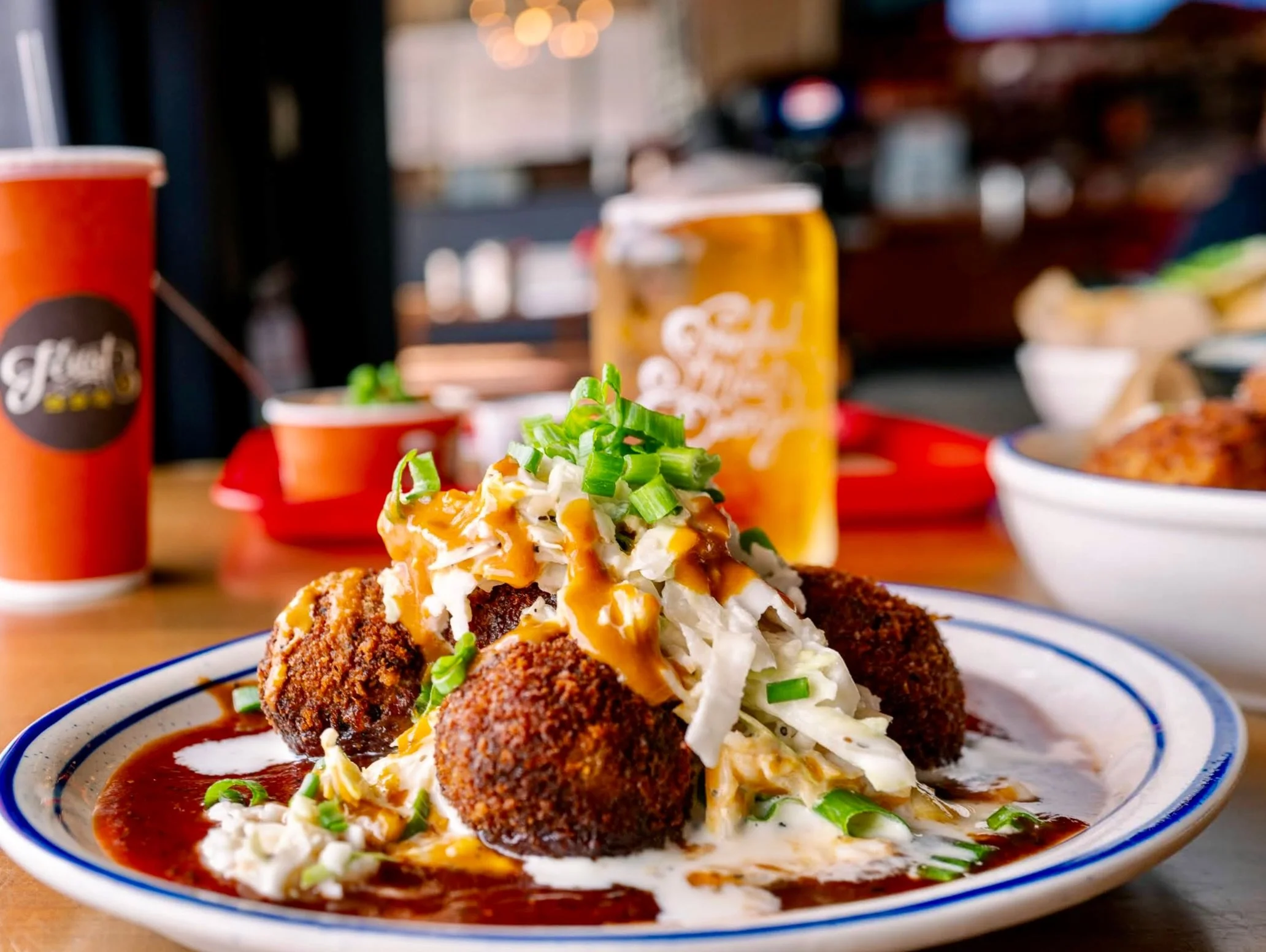 Pork Cake Poppers can be an app or meal, depending on how hungry you are. They&rsquo;re dense and delicious balls of pulled pork, green onions, slaw, and both original and mustard bbq sauces.

Dig in.