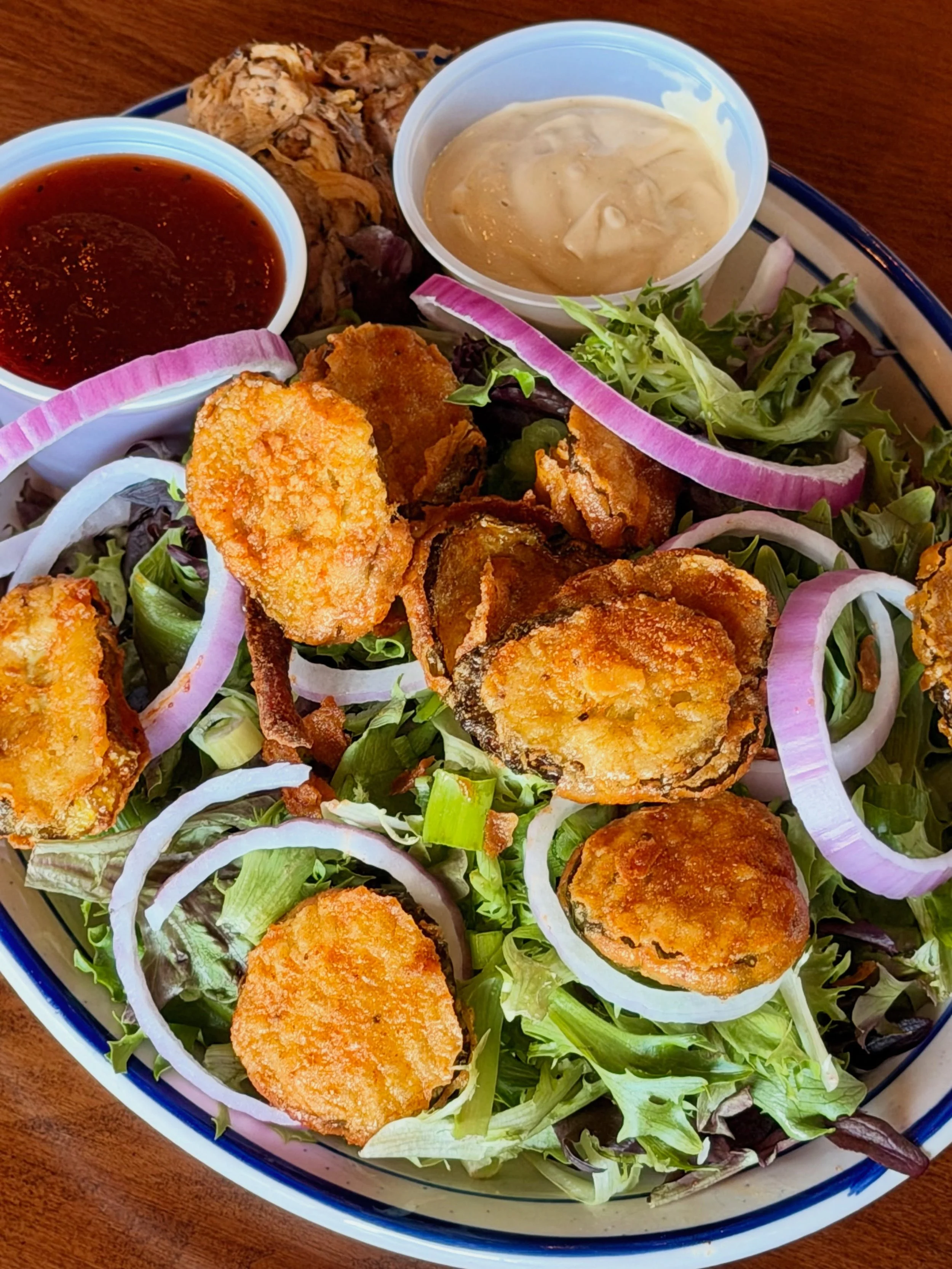 It&rsquo;s rare that a salad is craveable. But not impossible.

Our BBQ Salad includes pulled pork, Grippos-dusted fried pickles, bbq sauce, green onions, red onions, and smoked mustard dressing.